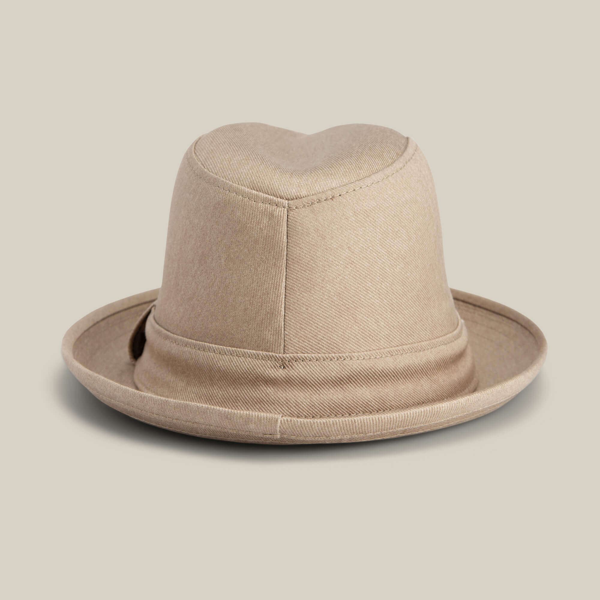 The "Big Stepper" by Goorin Bros. is a beige fedora hat with a folded brim and soft fabric texture, stylishly displayed against a plain light background.