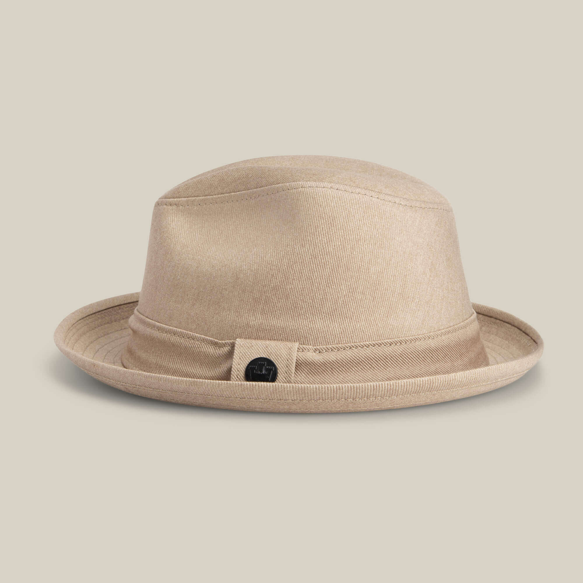 The Goorin Bros. "Big Stepper" is a beige fedora with a matching hatband and a small round black emblem on the side, displayed on a neutral background.