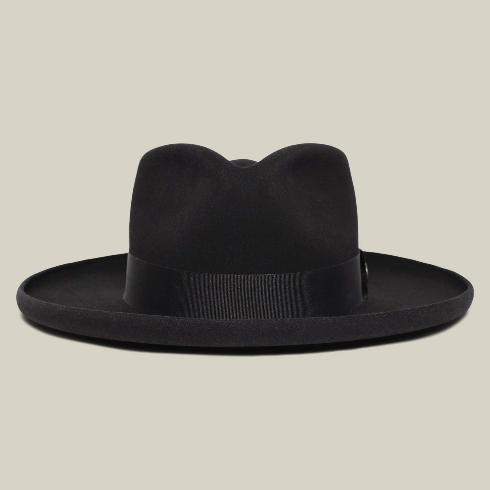 The Goorin Bros. Colonel Pierce is a black wide-brim fedora with a teardrop crown and black band, shown against a plain beige background.