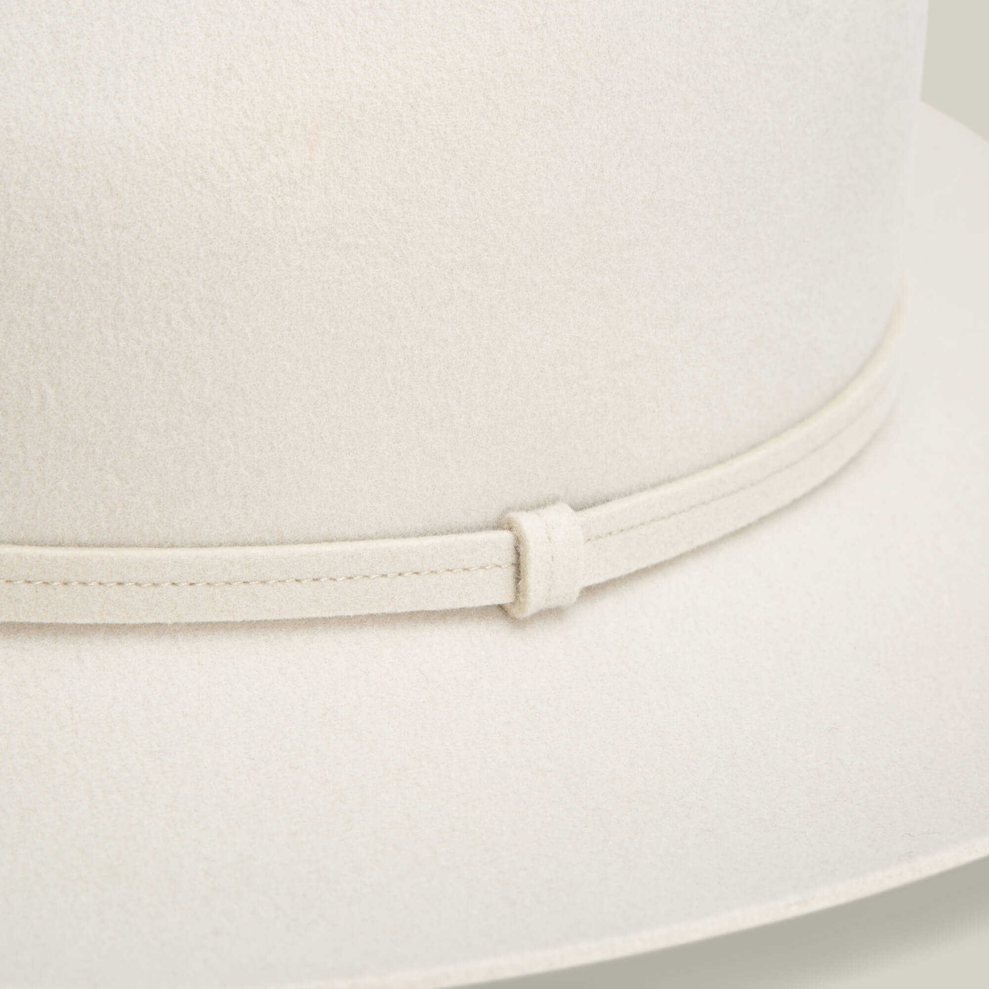 Close-up of the Goorin Bros. Night Hawk fedora in light beige, featuring a teardrop crown, matching thin band, and wide snap brim for versatile all-season style.