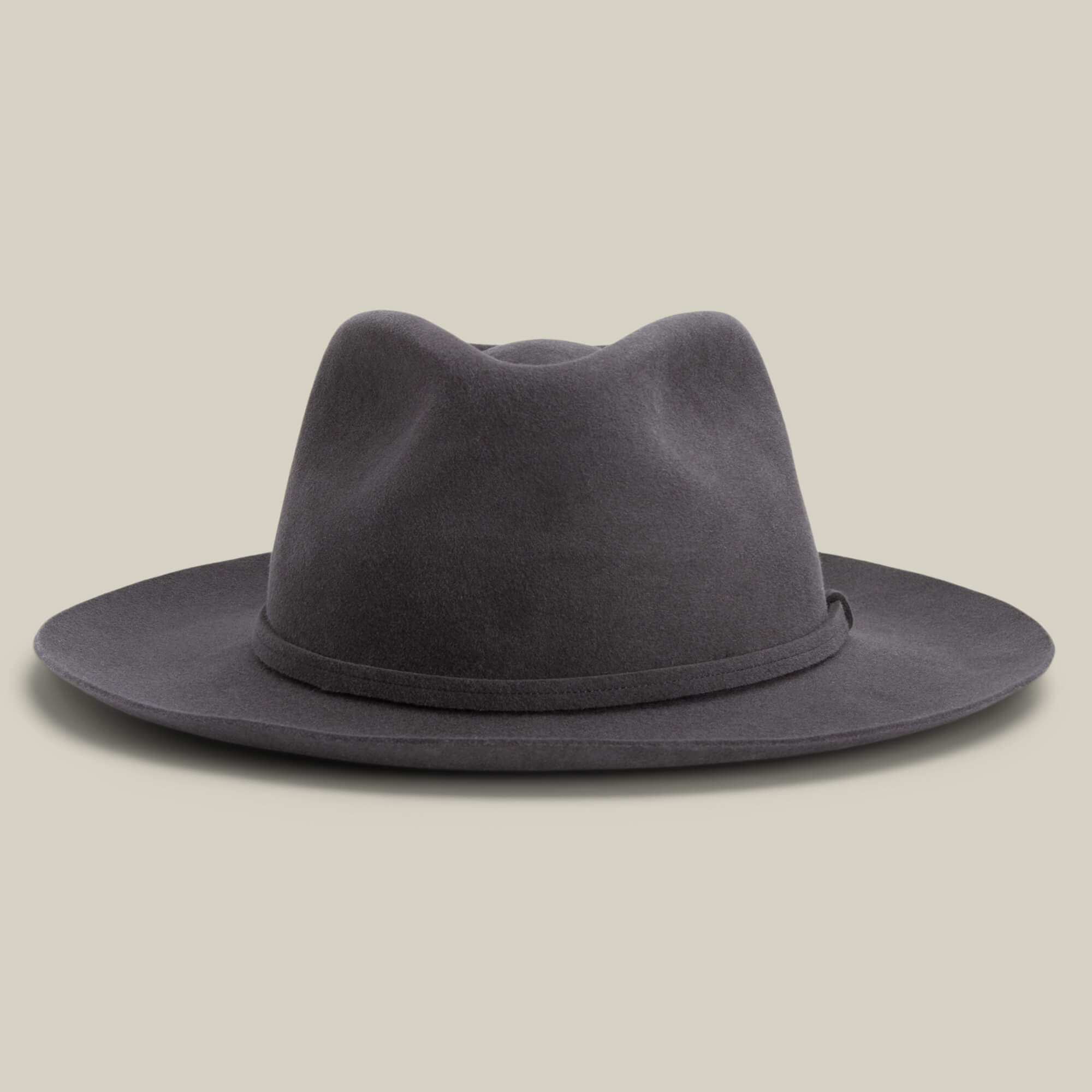 The Night Hawk by Goorin Bros. is a dark grey felt fedora featuring a teardrop crown, wide snap brim, and simple hatband—an elegant all-season accessory for any occasion, shown on a neutral background.