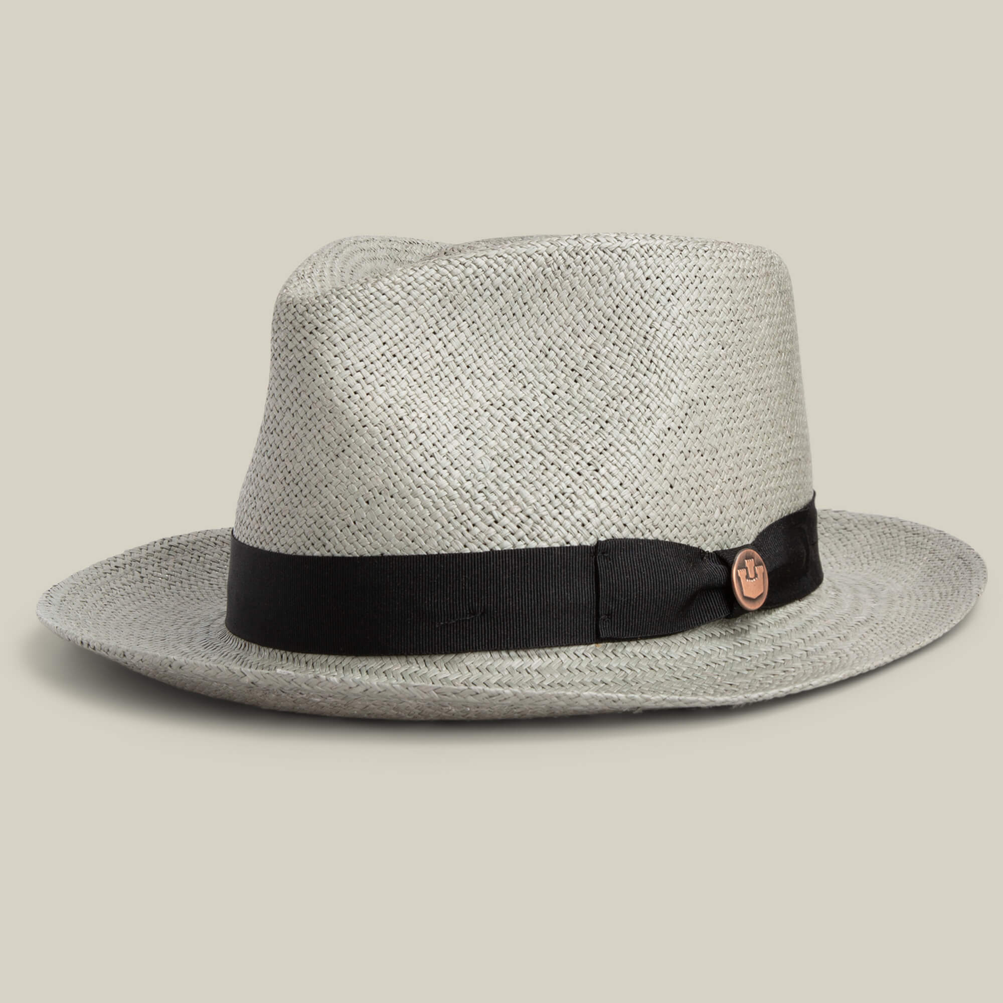 The Goorin Bros. John Sr. is a light toquilla teardrop fedora with a wide brim, black ribbon band, circular side emblem, and 50 UPF sun protection, shown against a plain background.