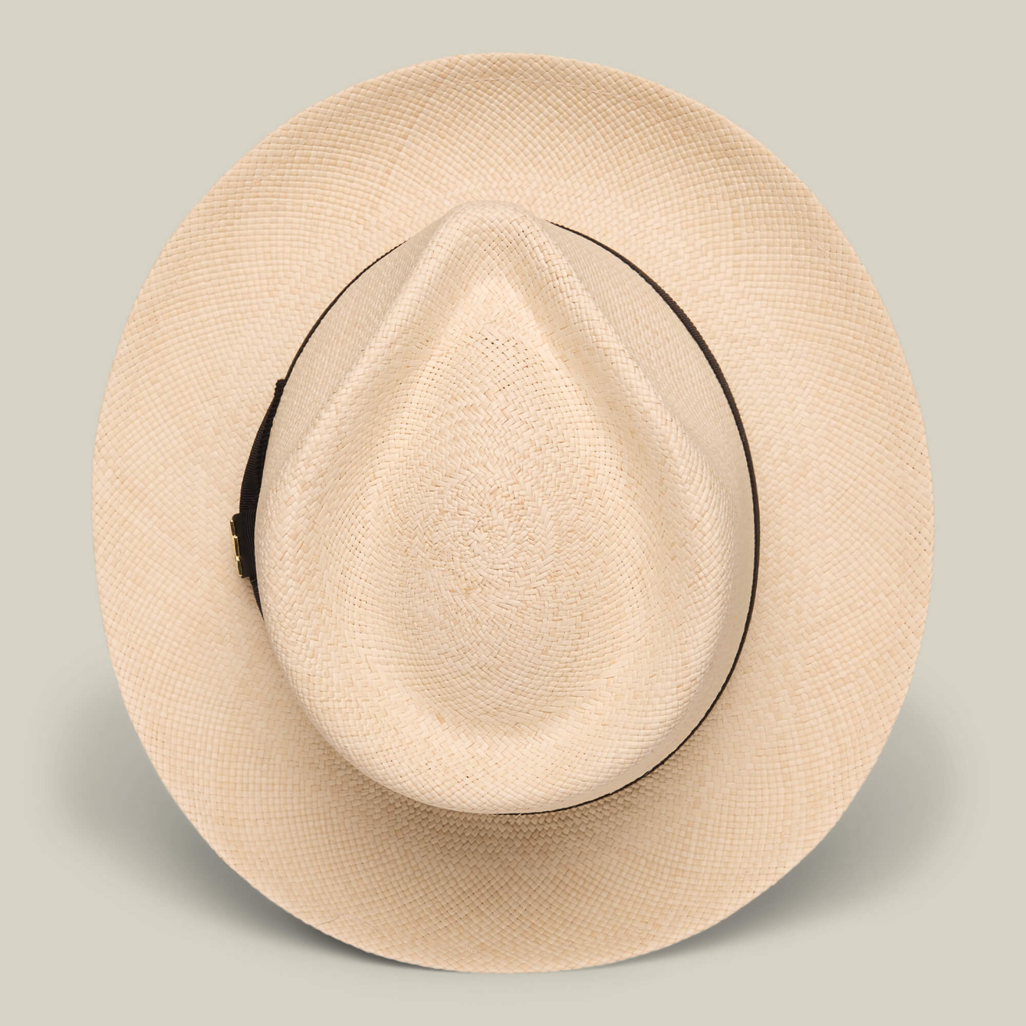 The Goorin Bros. John Sr. is a beige toquilla teardrop fedora with a wide brim, dark band, and 50 UPF sun protection, shown from above on a plain background.