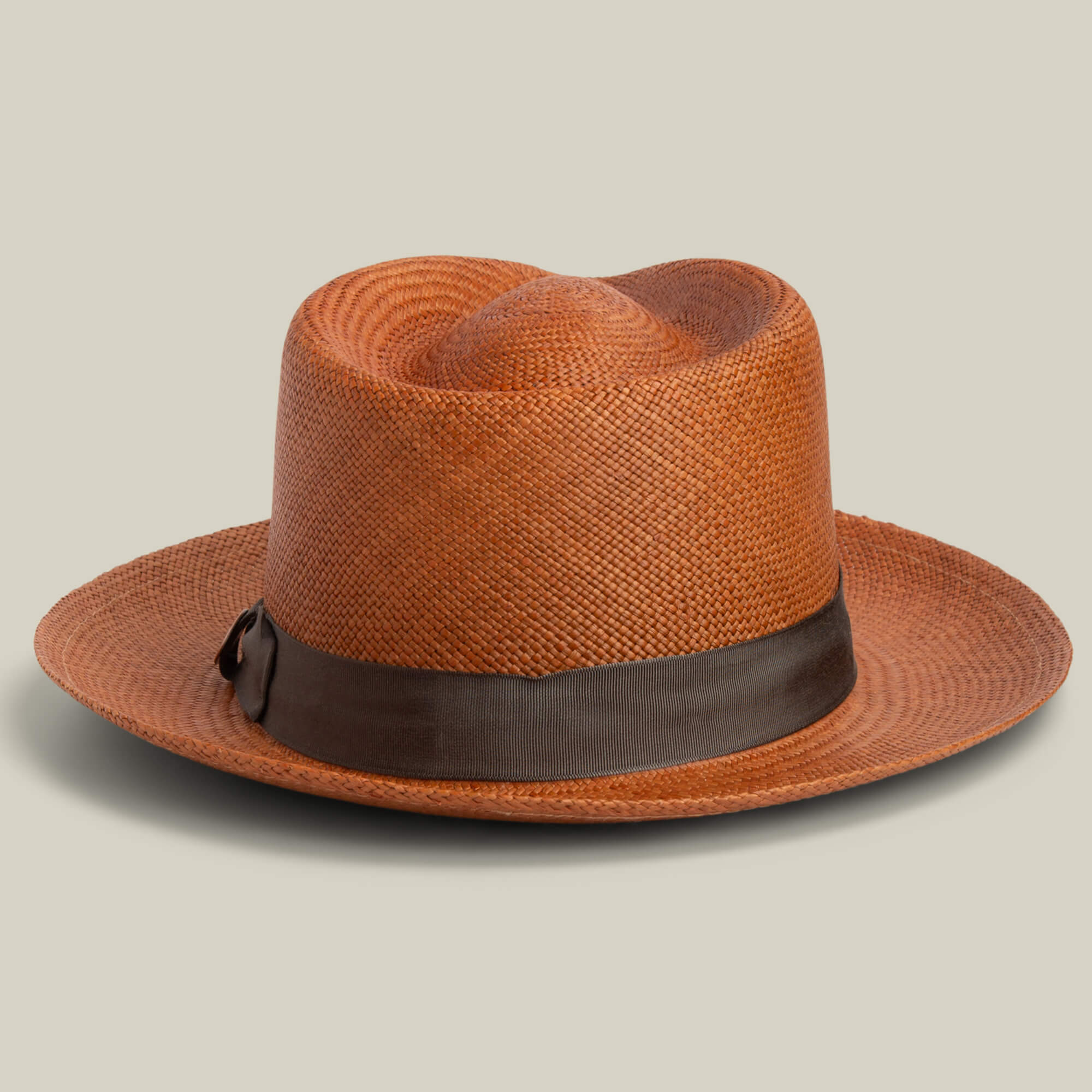 The Goorin Bros. John Sr. is a brown toquilla teardrop fedora with a wide brim, dark brown ribbon band, and 50 UPF sun protection, shown against a plain light background.