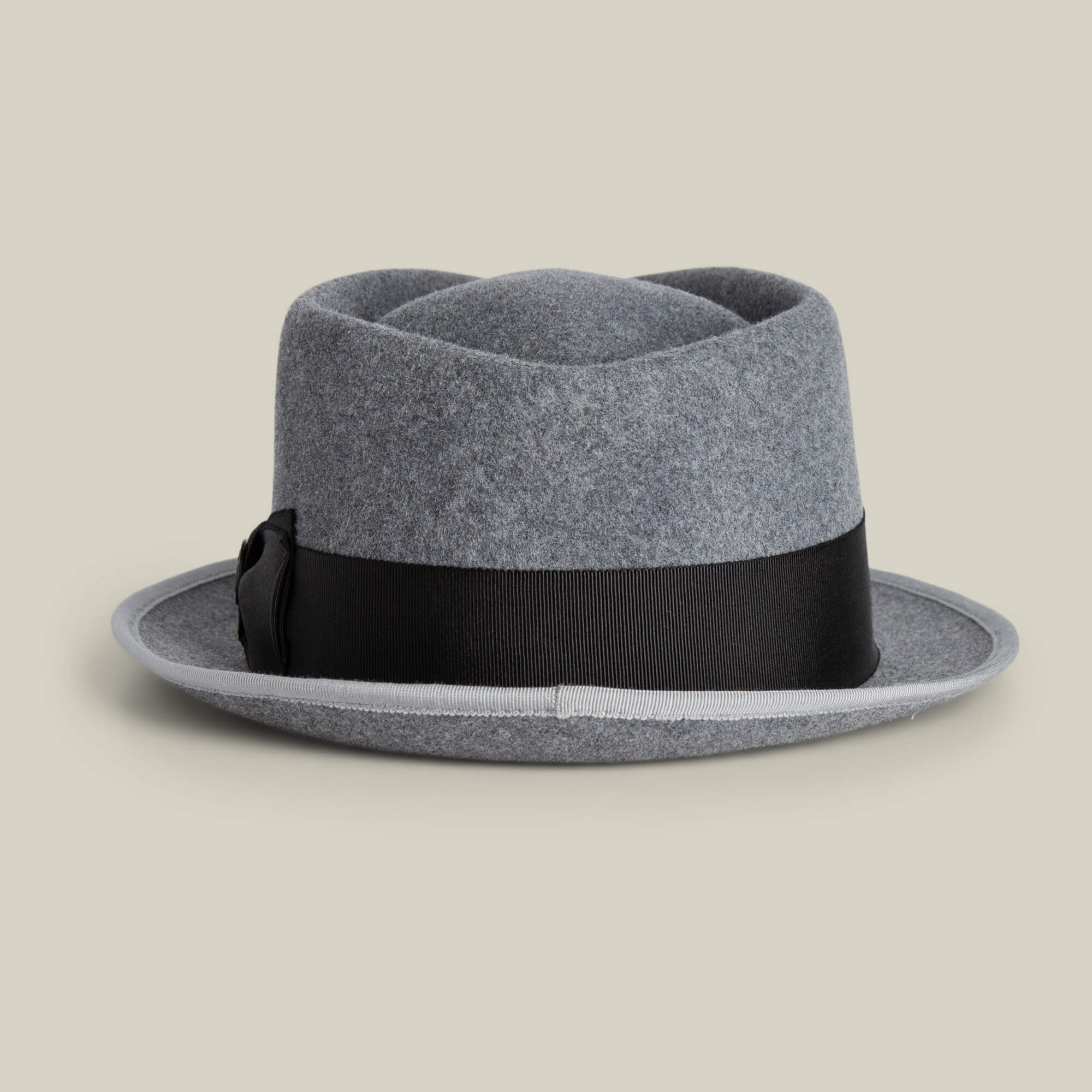 The Slick Carter by Goorin Bros. is a grey felt fedora hat with a black ribbon band, short wool brim, and minimalist style, showcased against a plain light background.