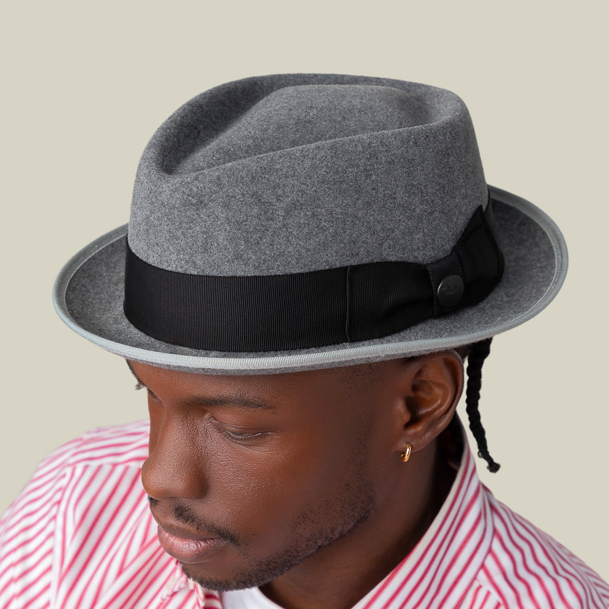 Wearing the Slick Carter by Goorin Bros., a gray wool short brim fedora with a black band, paired with a pink and white striped shirt, this person exudes effortless style from a slightly elevated angle.