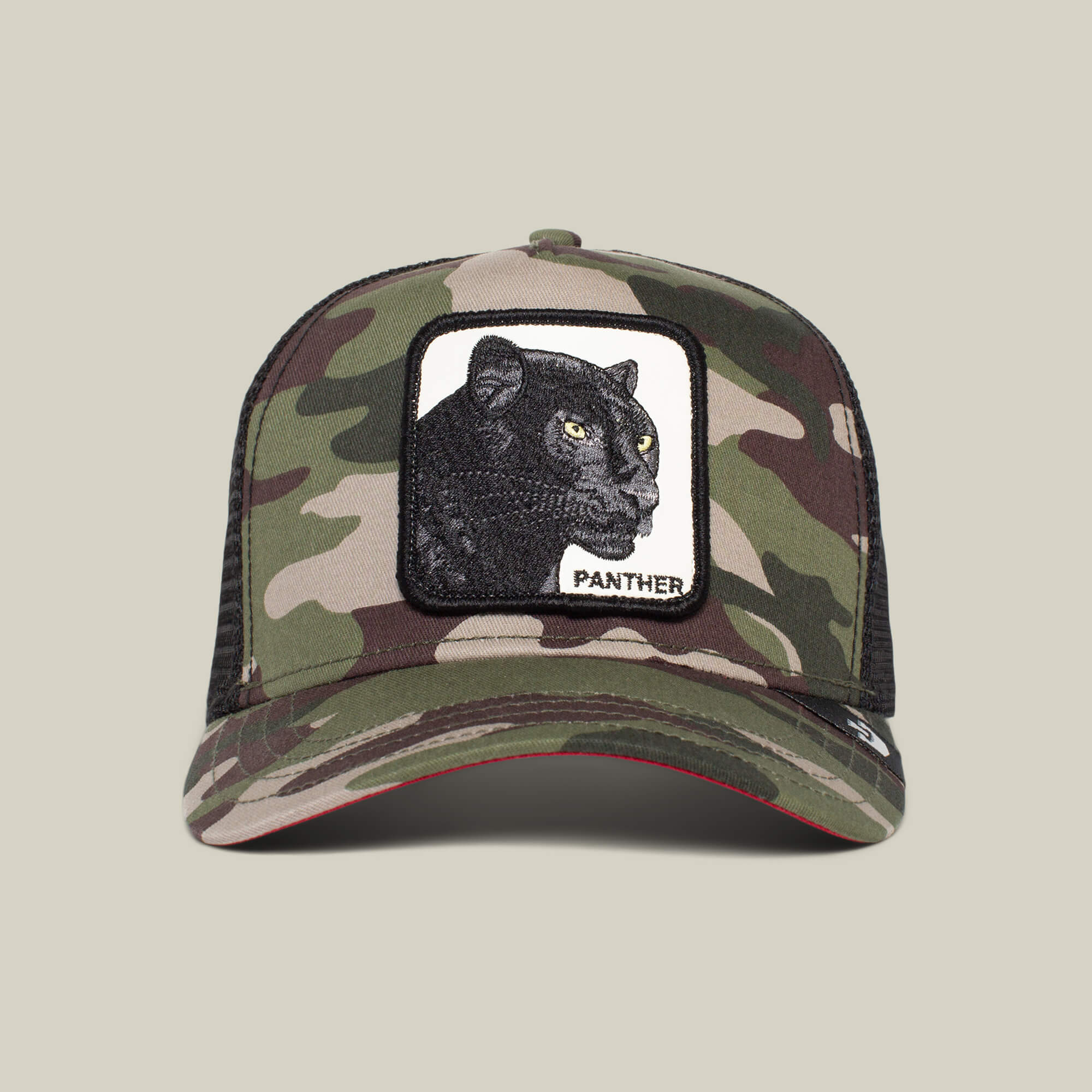 The Panther by Goorin Bros. is a camouflage trucker hat with a mesh back and front patch showing an embroidered black panther and "PANTHER"—perfect for The Farm collection fans.