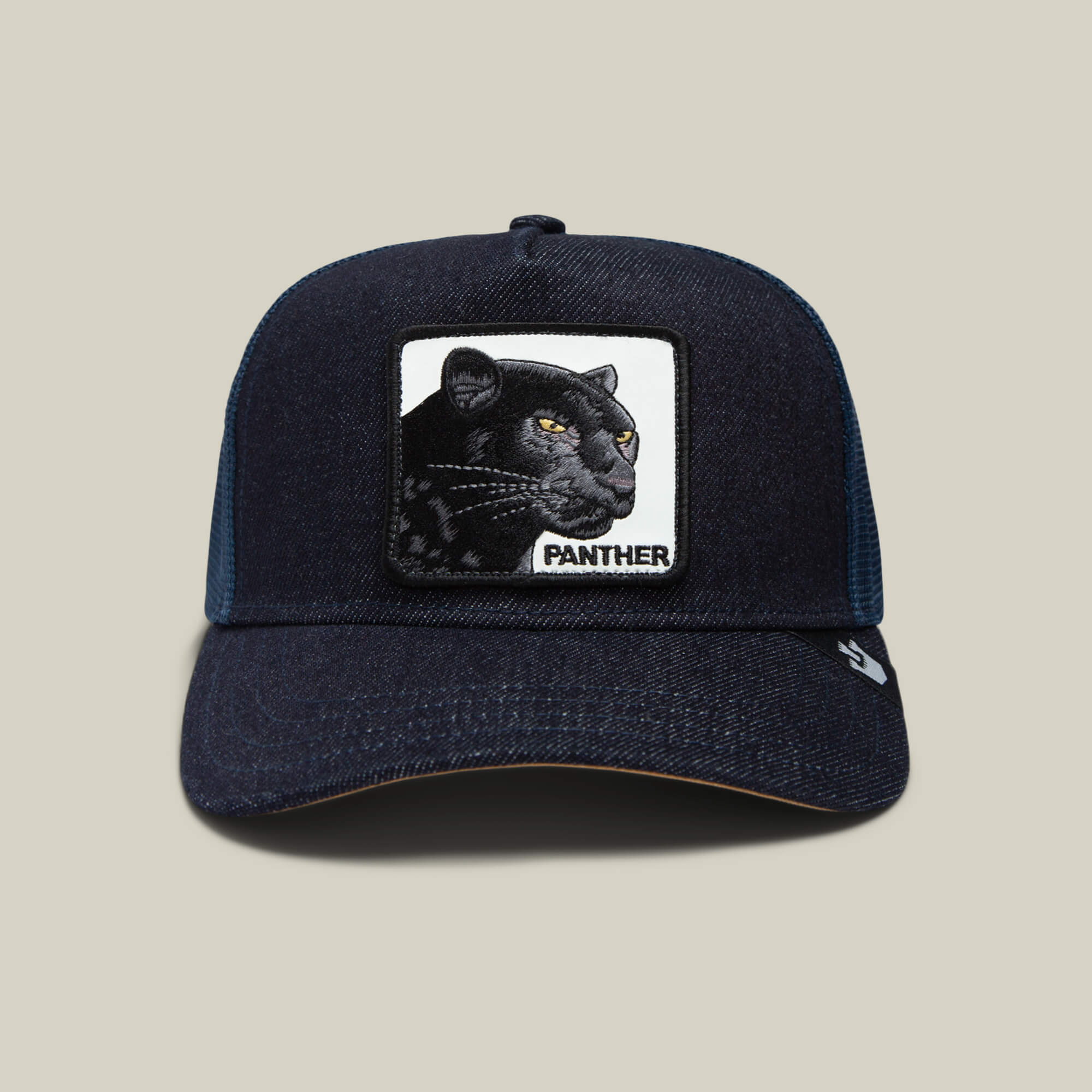 The Panther by Goorin Bros. is a dark blue trucker hat with a mesh back and a front patch displaying an embroidered black panther head and the word "PANTHER.