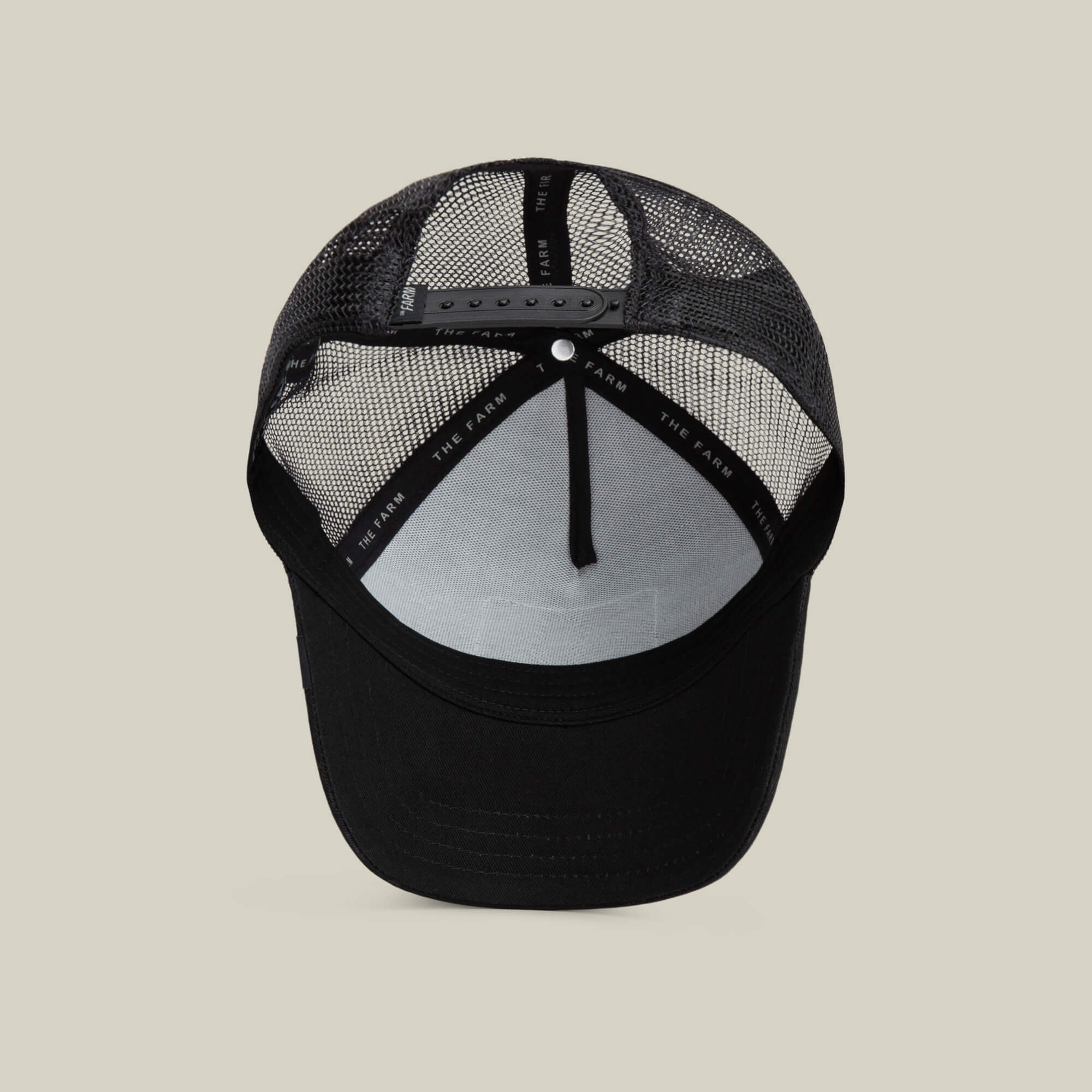 The Freedom Eagle by The Farm is a black trucker hat with a breathable mesh back, adjustable snap closure for a secure fit, and a black sweatband to keep sweat at bay.