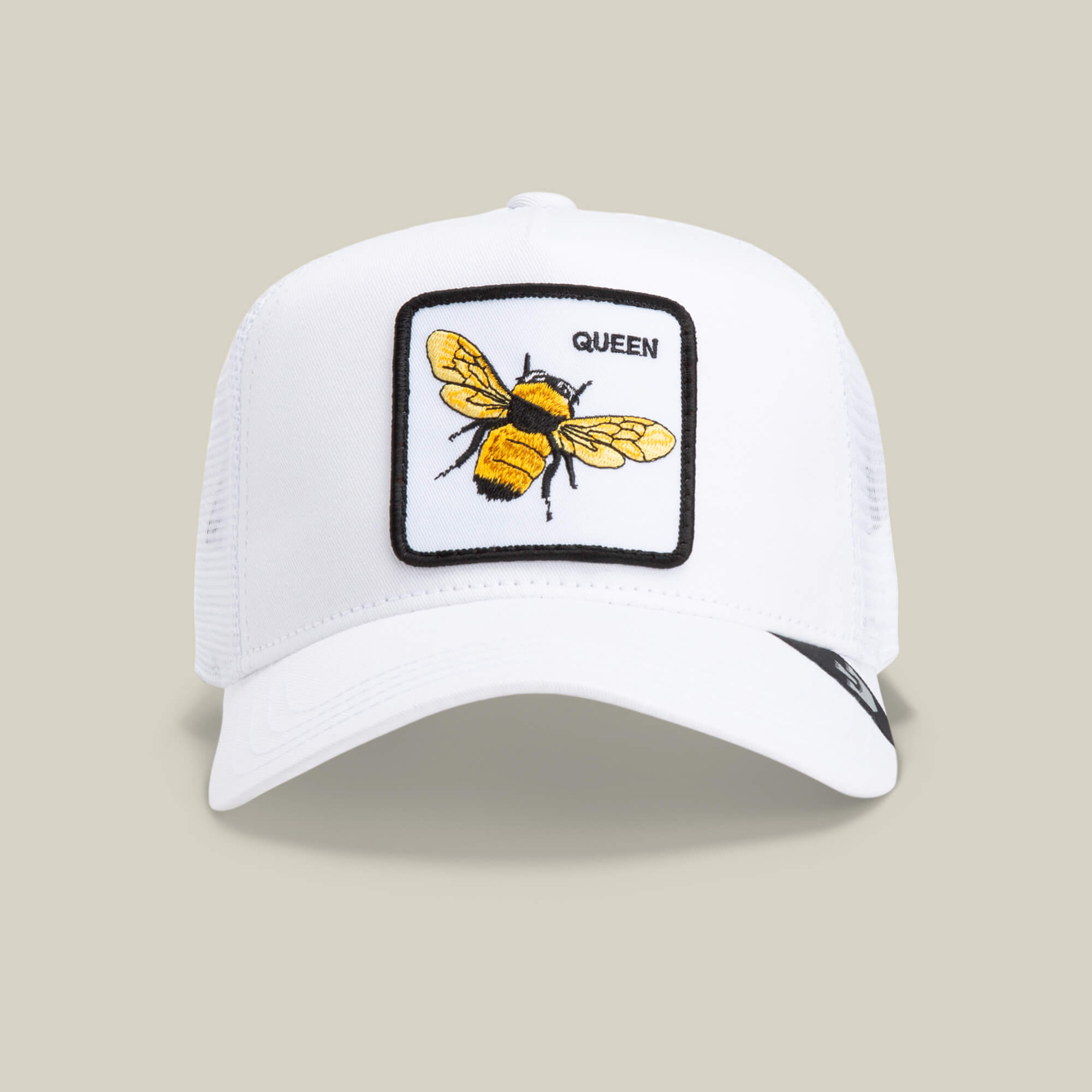 The Farm's "The Queen Bee" cap is a white mesh baseball hat with a front patch showing a yellow and black bee, the word "QUEEN" in black, plus a subtle crown accent.
