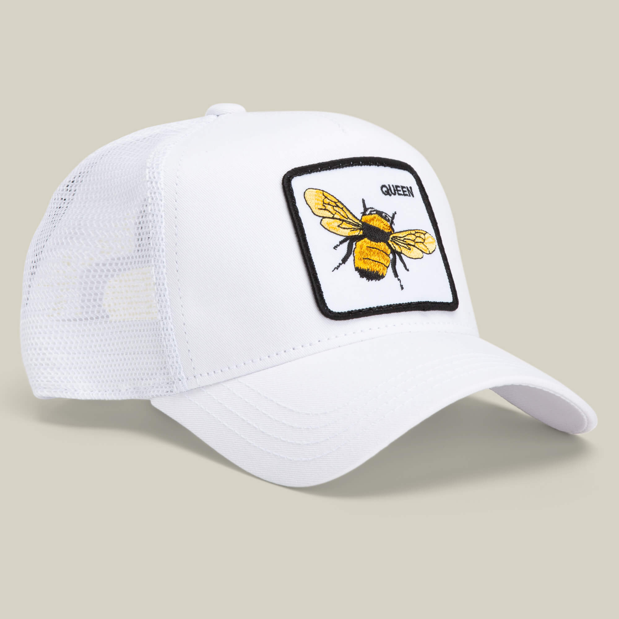 The Farm's "Queen Bee" cap is a white mesh baseball hat with a front patch featuring an embroidered yellow bee and the word QUEEN—ideal for anyone ready to slay and claim their crown.