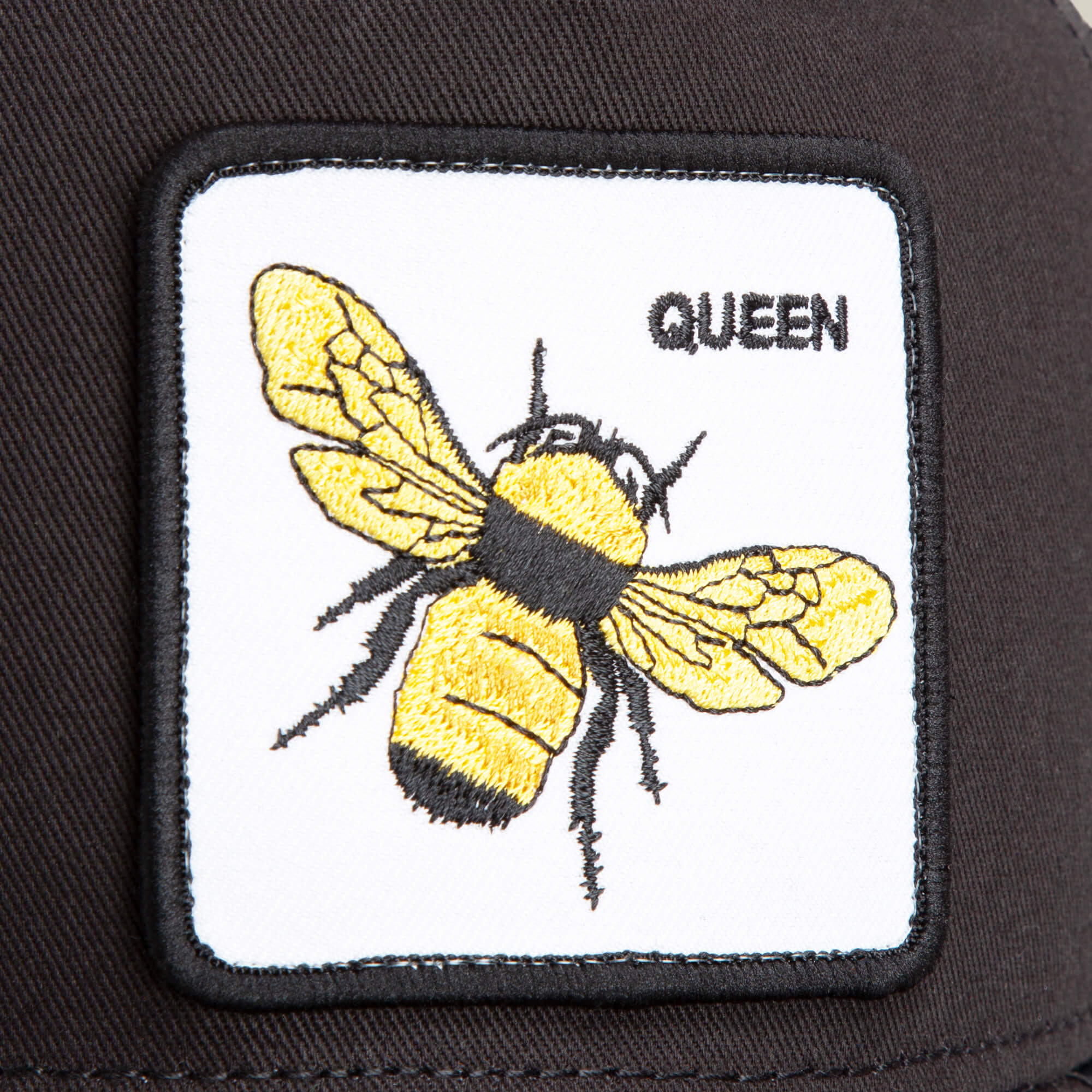The Farm’s "The Queen Bee" patch features an embroidered yellow-and-black bee with a crown above the word QUEEN, all on a sleek black fabric.