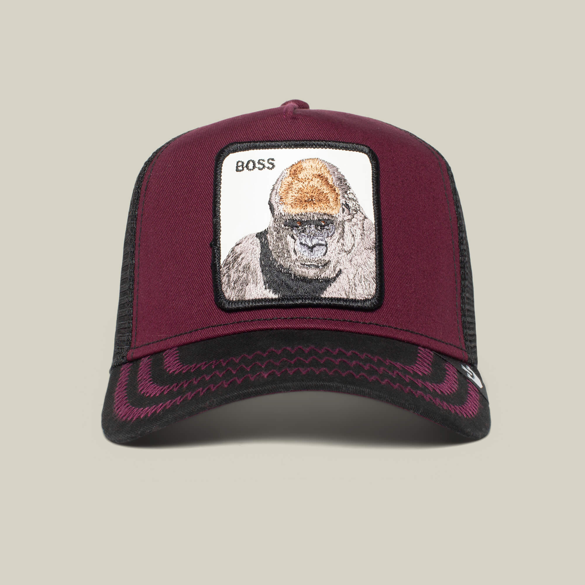 The Farm’s “The Boss” trucker hat features a maroon and black design with a patch showing an 800 pound gorilla and the word BOSS at the top left.