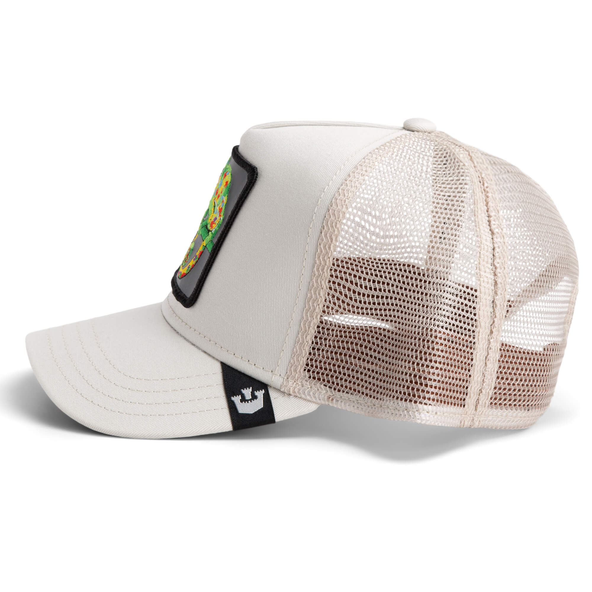 The Farm's Karma Chameleon is a beige and white mesh trucker hat with a curved brim and a rectangular front patch, adding good karma to your everyday style.