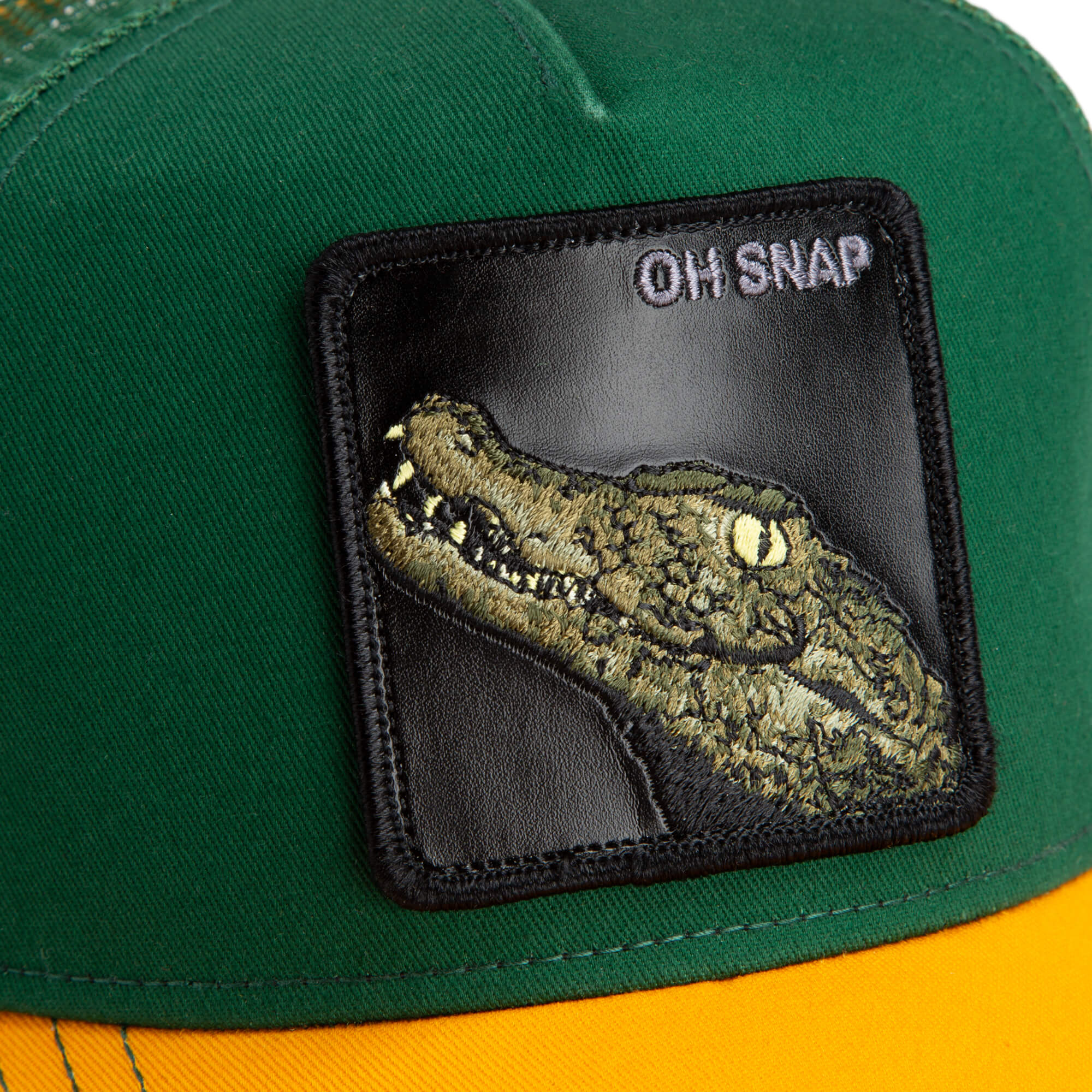 The Farm’s The Oh Snap Alligator cap features green and yellow colors, a black patch with an embroidered crocodile head, and "OH SNAP" text in the upper right corner. All sales final.