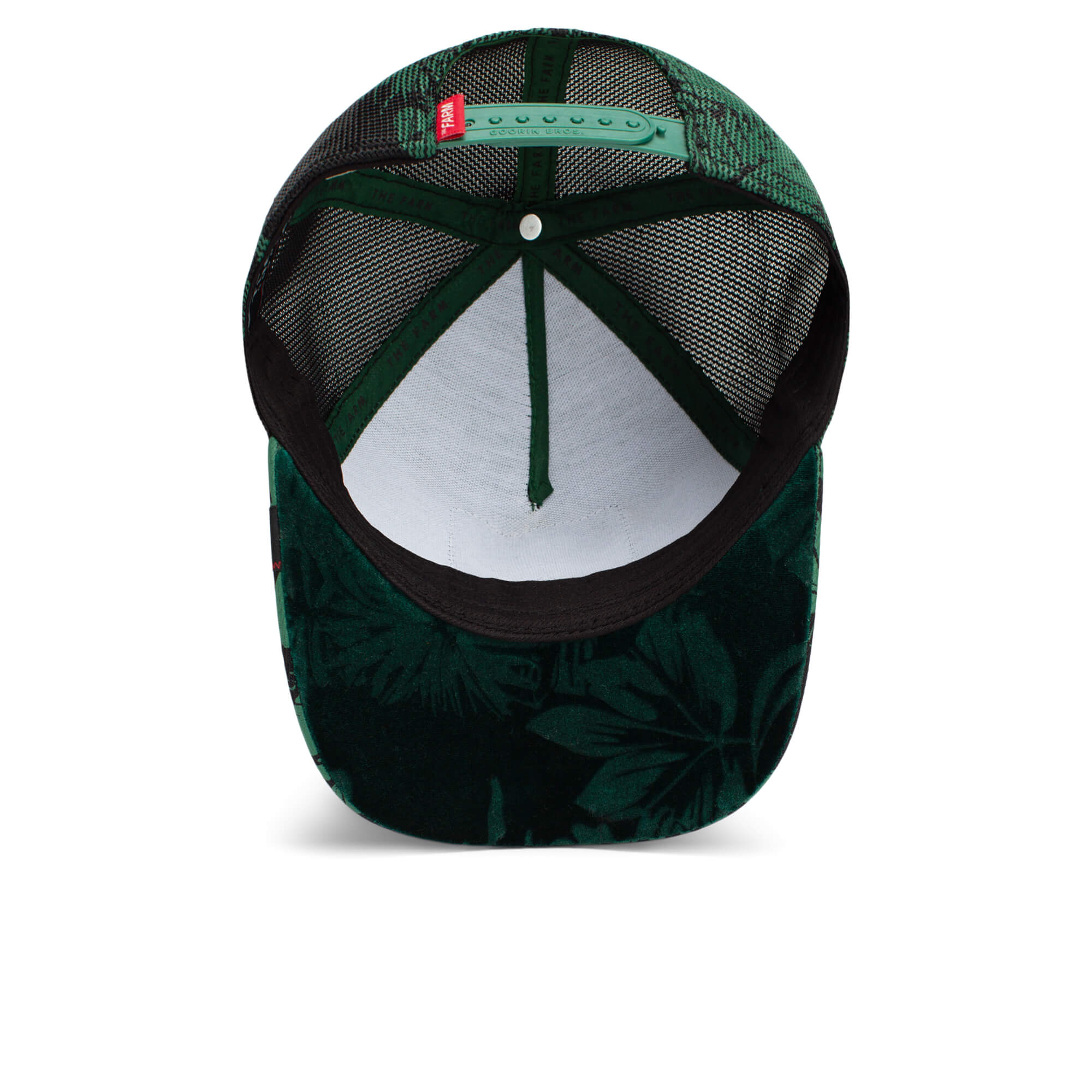 The Farm Slash trucker hat in green and black, featuring a tropical leaf-patterned brim, mesh back, and adjustable strap. All sales are final.