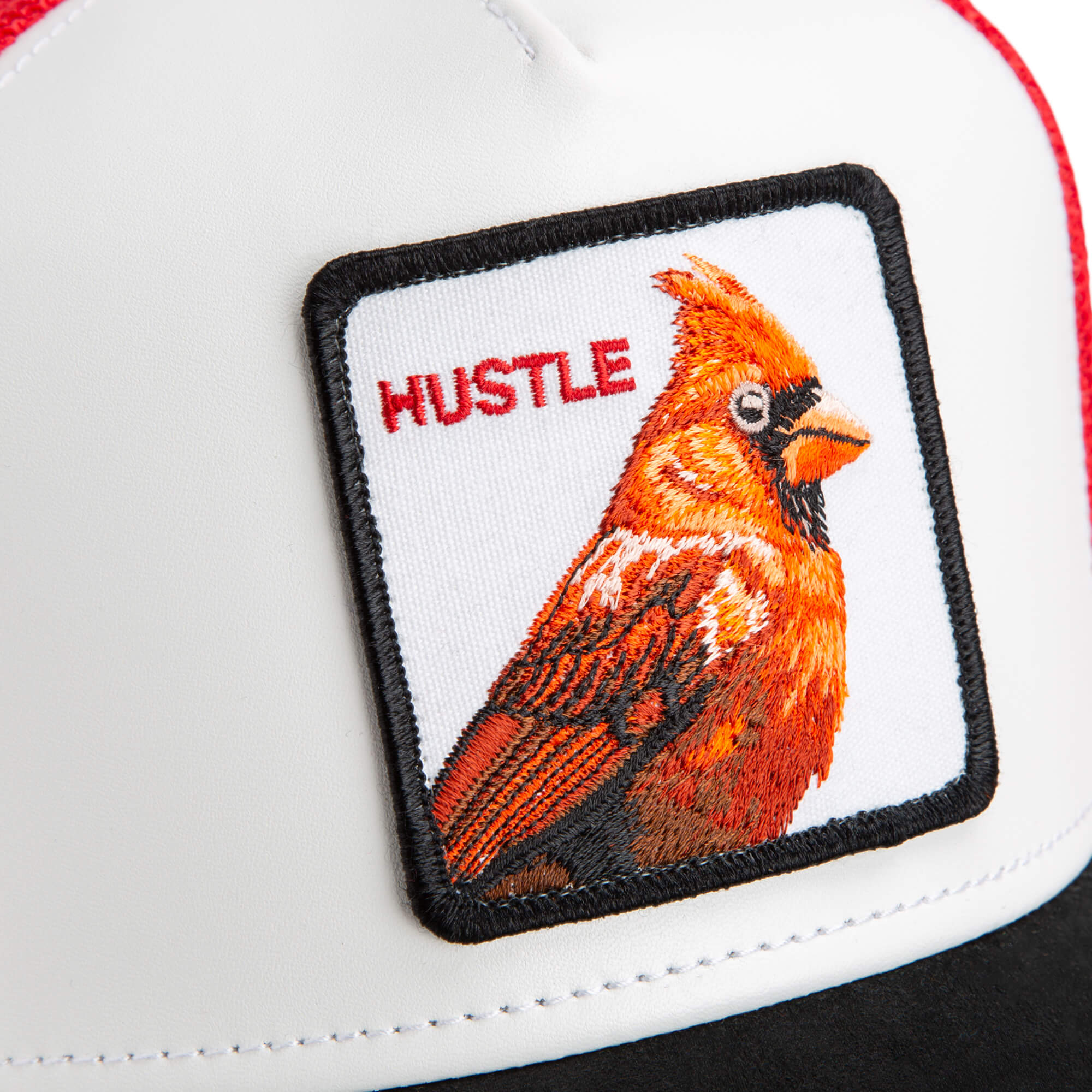 A white cap from The Farm, called "TF is Bustle?", features a stitched patch with an embroidered red cardinal and the word HUSTLE in red. All sales are final.