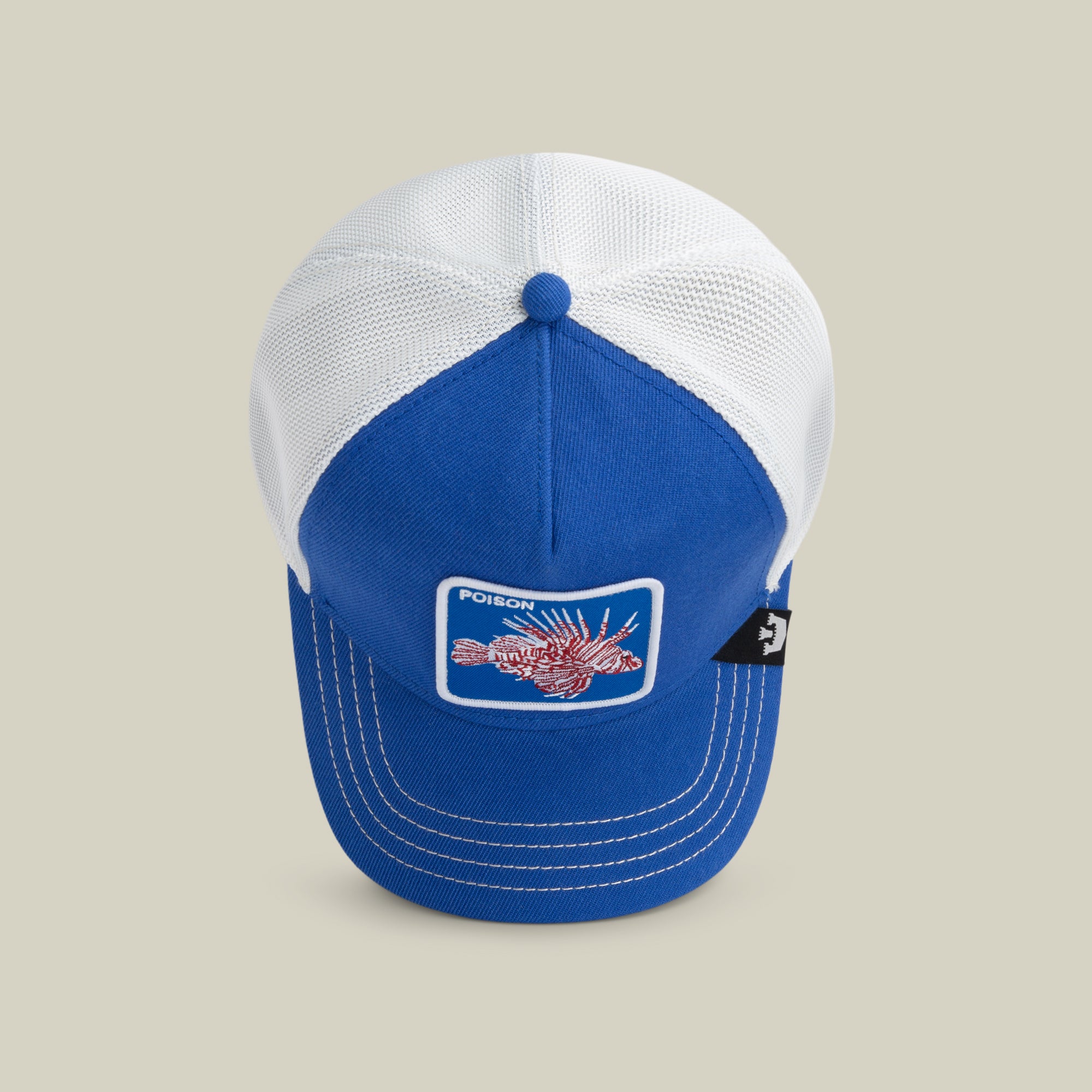 A blue and white baseball cap by The Farm called Lionfish Heat, featuring a lionfish patch with "POISON" on the front. All sales are final.