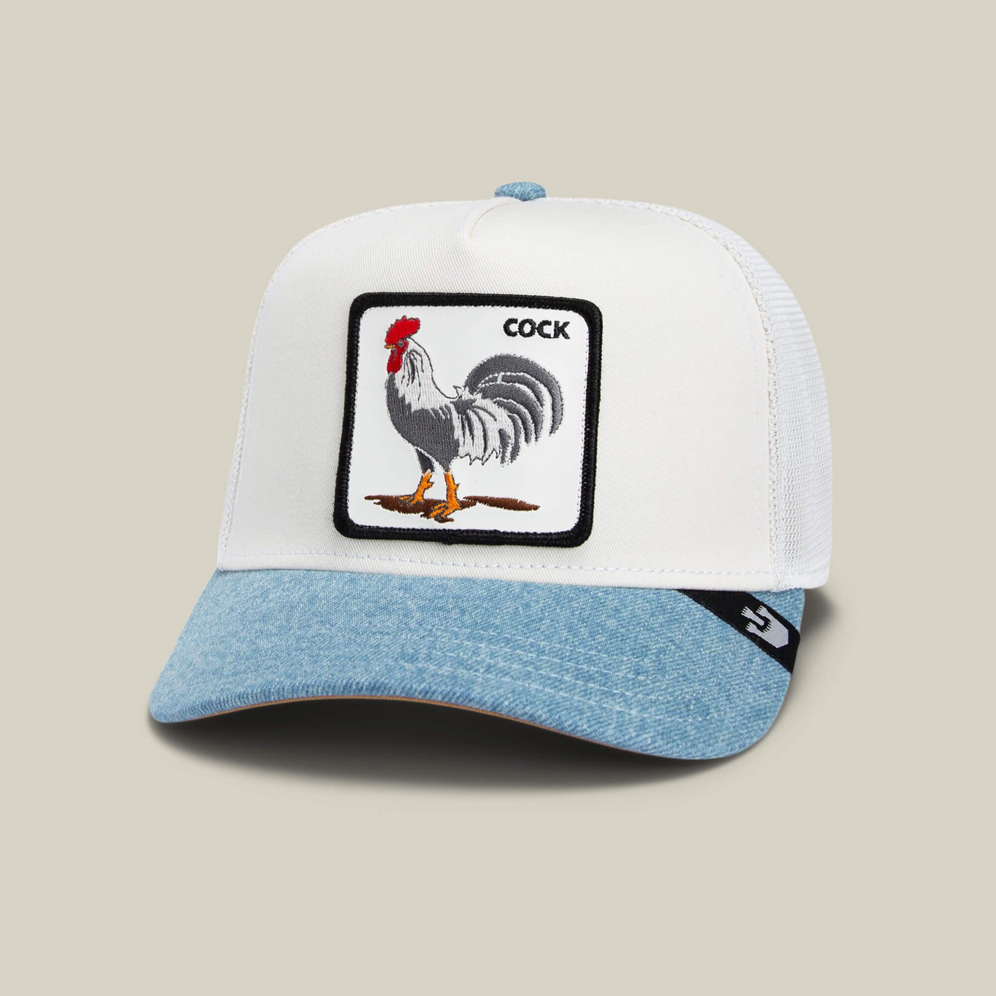 The Goorin Bros. Rooster Fan Institution Ball Club cap features a white and light blue trucker design with an embroidered rooster and "COCK" on the front—perfect for bold, game-day style.