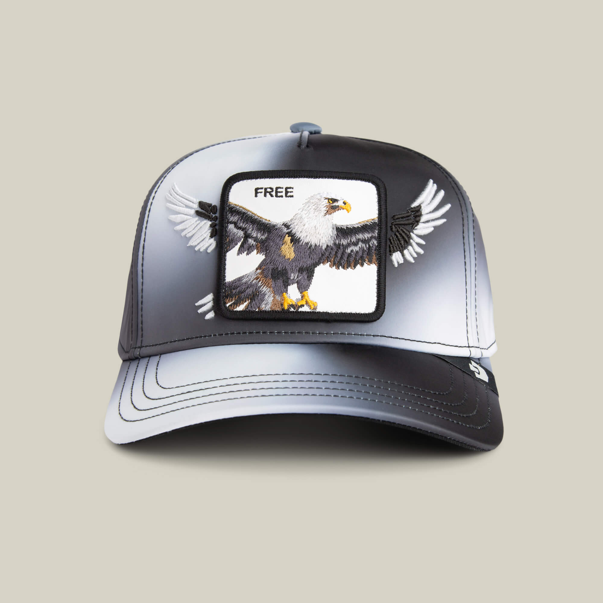 The Steal This Hat by Goorin Bros. is a black and white baseball cap featuring a bold bald eagle patch with "FREE" above it, adding a striking touch to your style.