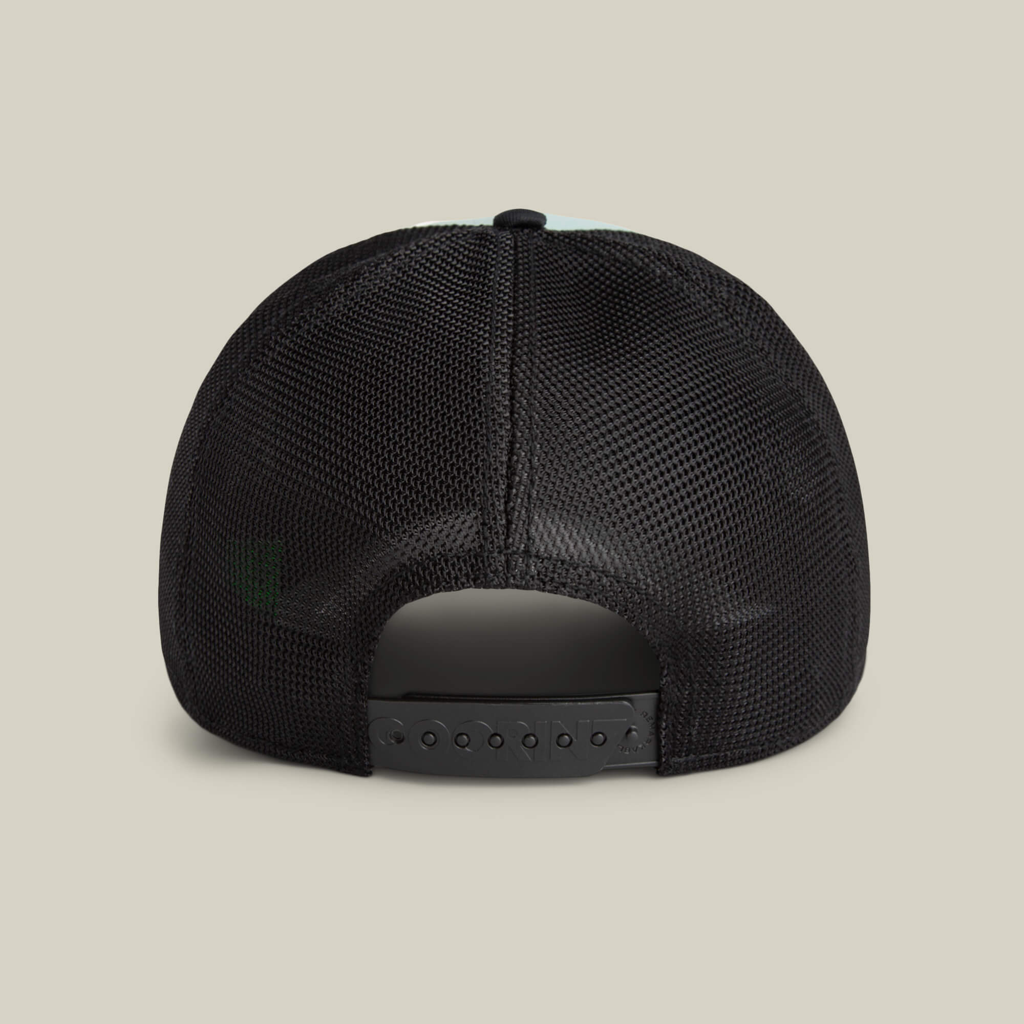 Back view of the Goorin Bros. Means Agreed black mesh trucker hat with an adjustable snapback, set against a beige background—pair it easily with your favorite casual shirt for laid-back style.
