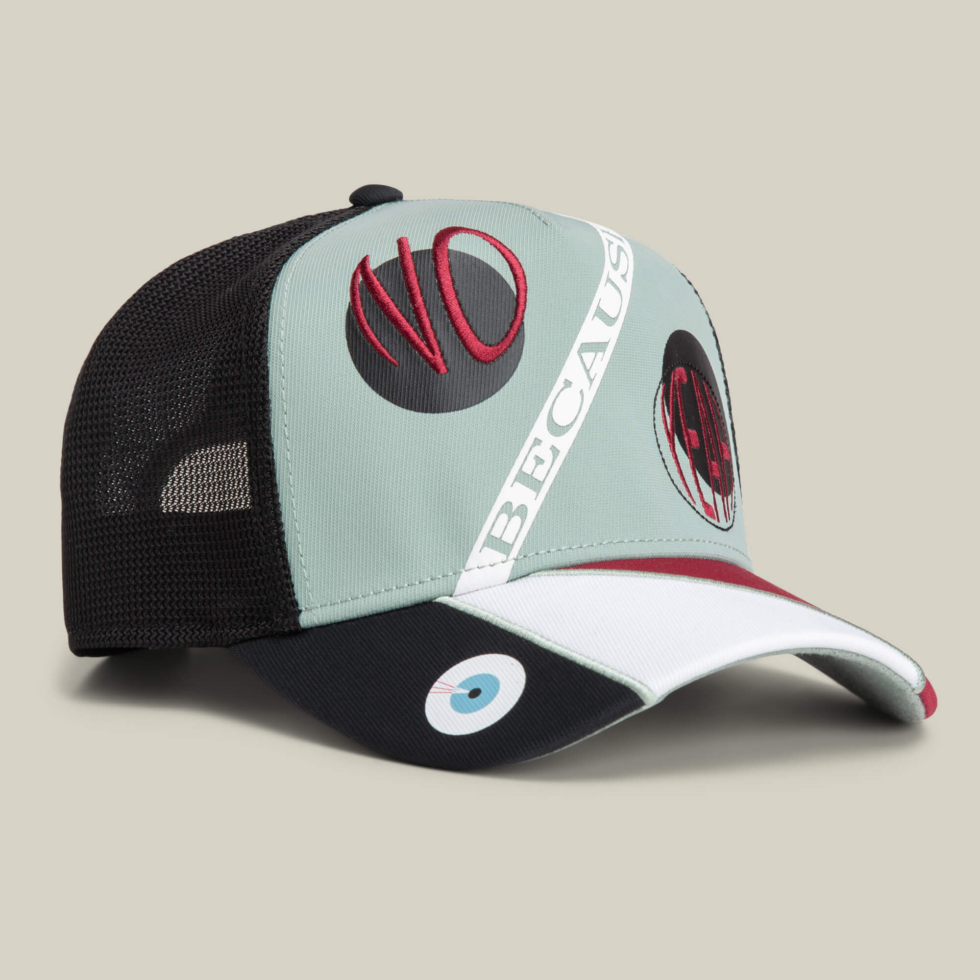 The Goorin Bros. Means Agreed trucker hat features mesh back, light blue front, red and black "NO" and "OK, BECAUSE" embroidery, and a stylized eye on the brim—perfect with your favorite “no because yeah” tee for confident style.