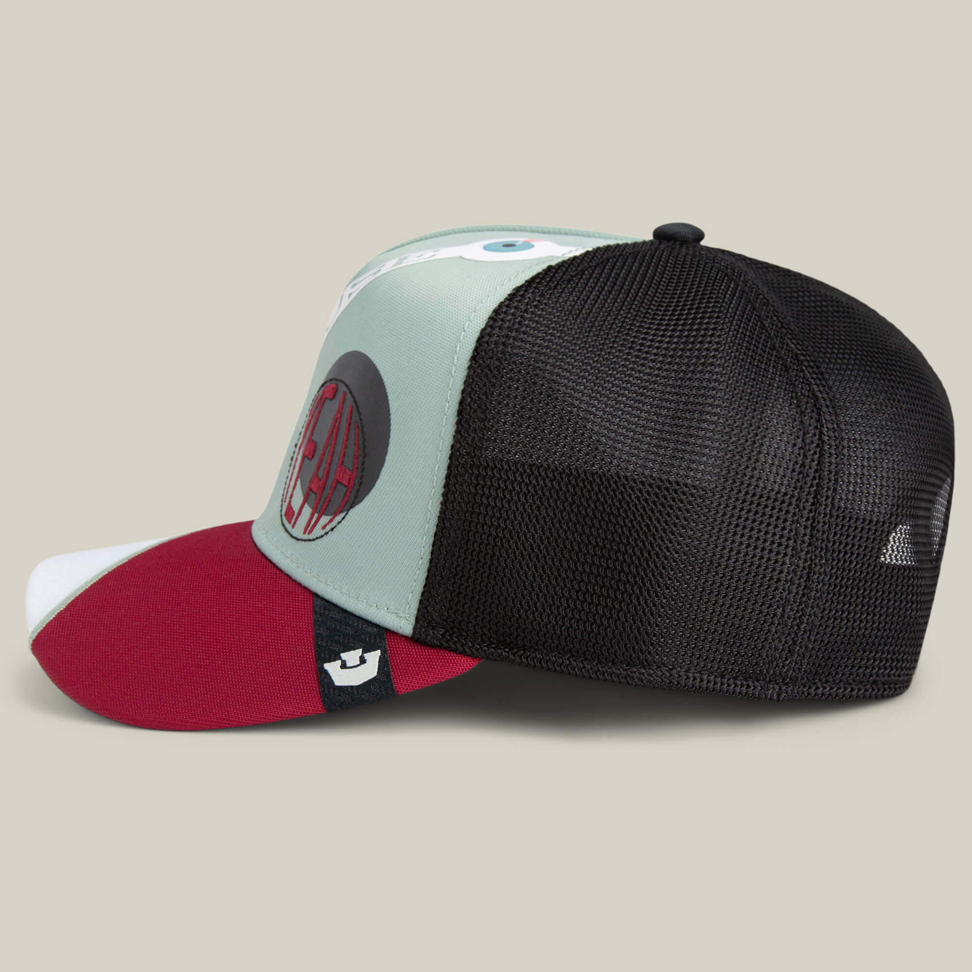 The Means Agreed trucker hat by Goorin Bros. features a mint green front, red bill, black mesh back, and AC Milan logo patch—ideal for pairing with your confident casual shirt for a bold, sporty look.