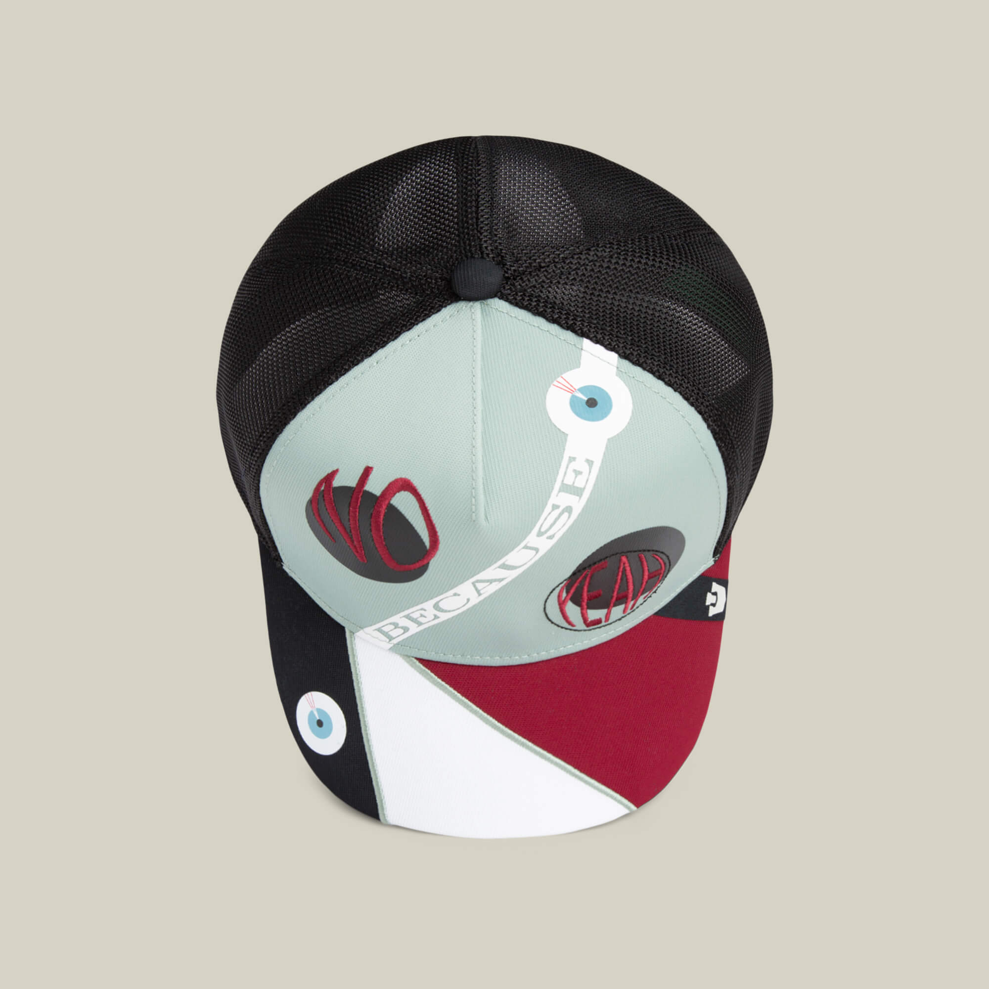 The Means Agreed by Goorin Bros. is a multicolored trucker hat with mesh sides, abstract color blocks, and bold NO, FEAR, and BECAUSE text patches on the front and brim for a standout statement look.