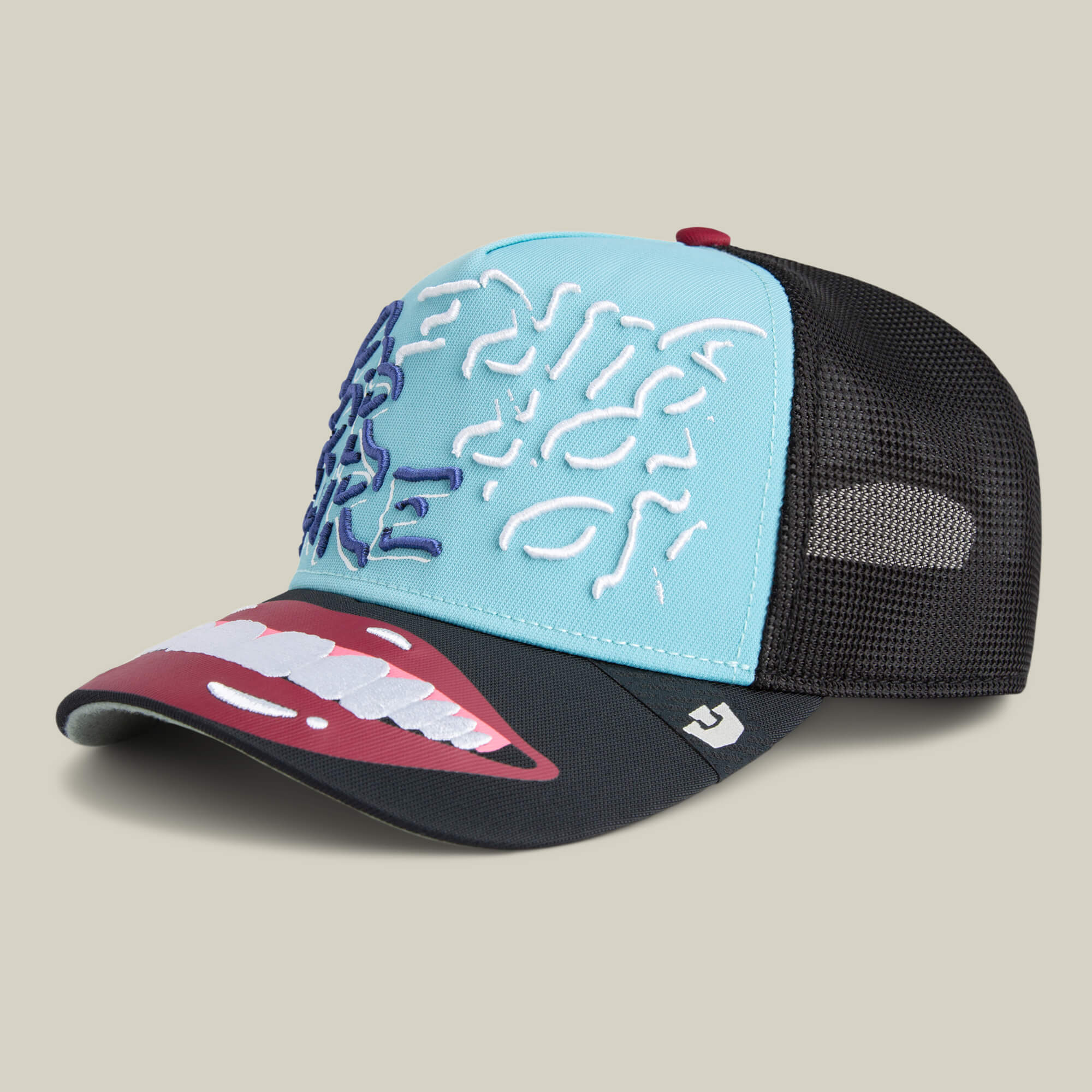 Goorin's "Means Understood" is a blue and black mesh trucker hat featuring an embroidered brain on the front panel and a bold open mouth graphic on the brim, perfect for showcasing your confidence.