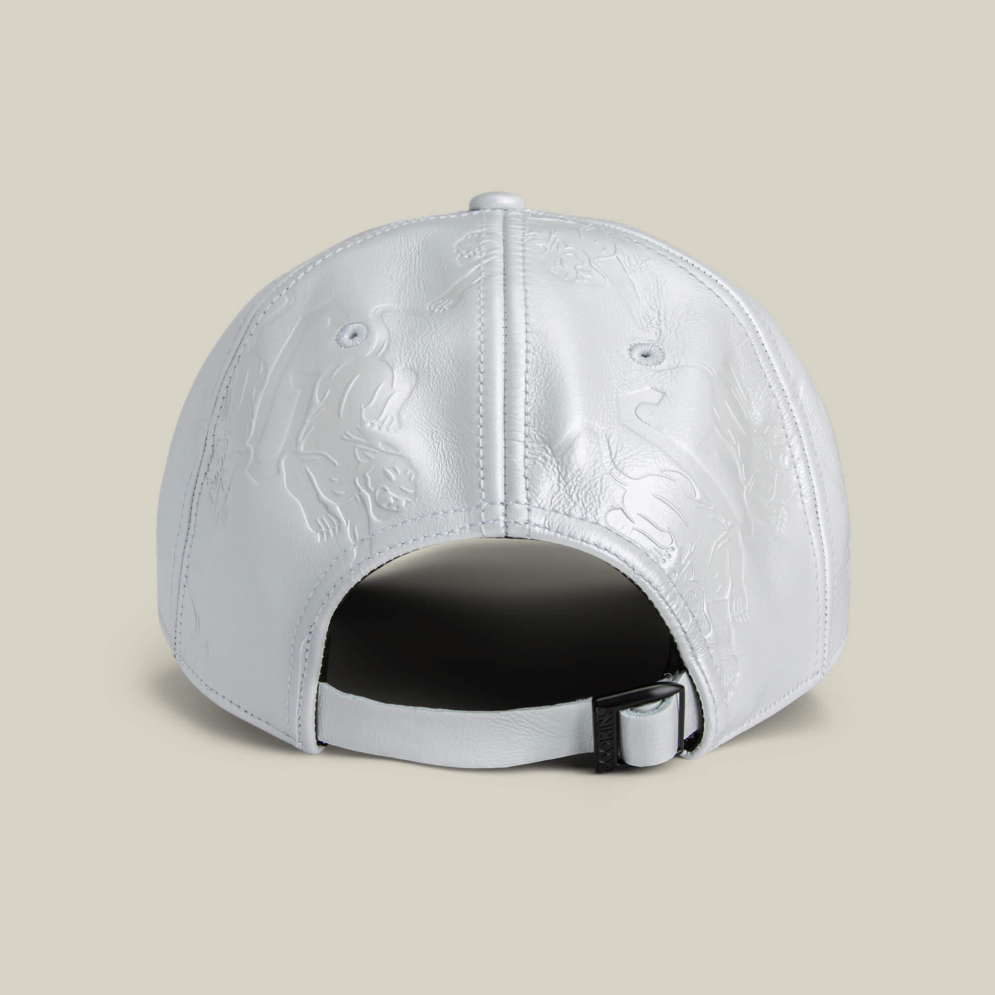 The Put a Panther On It hat by Goorin Bros. is a white leather cap with embossed panther designs and an adjustable strap featuring a metal buckle for a classic fit, shown from the back.