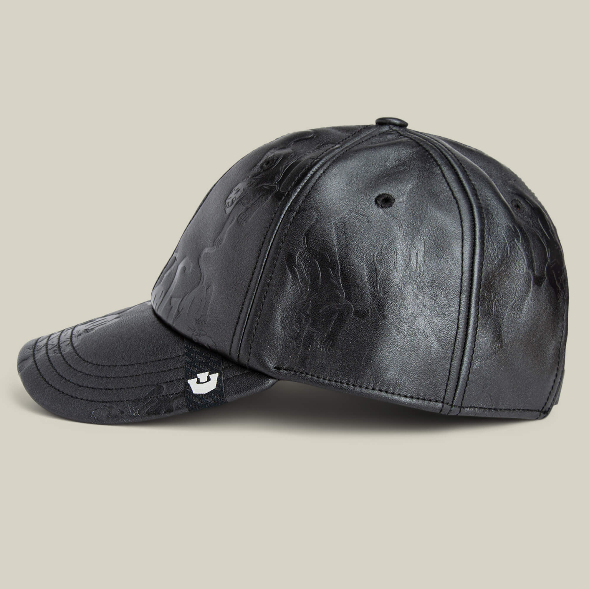 The Goorin Bros. "Put a Panther On It" black leather baseball cap, embossed with patterns and shown in a classic side view, stands out against a simple light background.