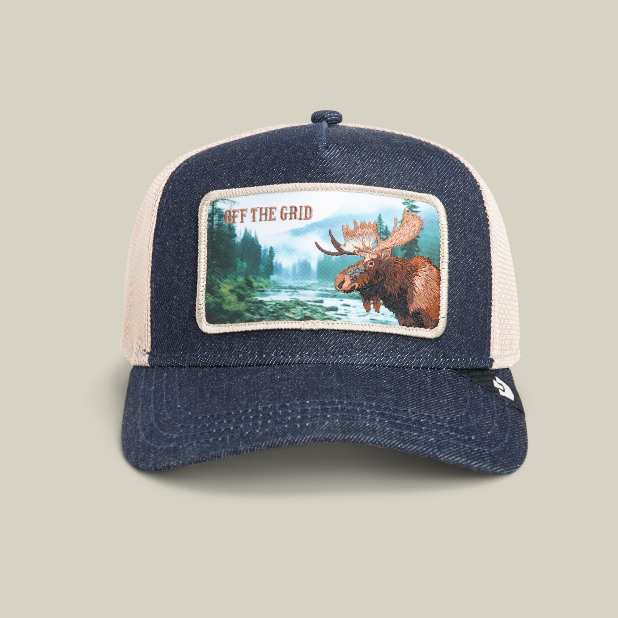 The Goorin Bros. Staycation hat in GRAY DENIM features a mesh design, a denim crown, a moose patch with a forest river scene, and the text OFF THE GRID.
