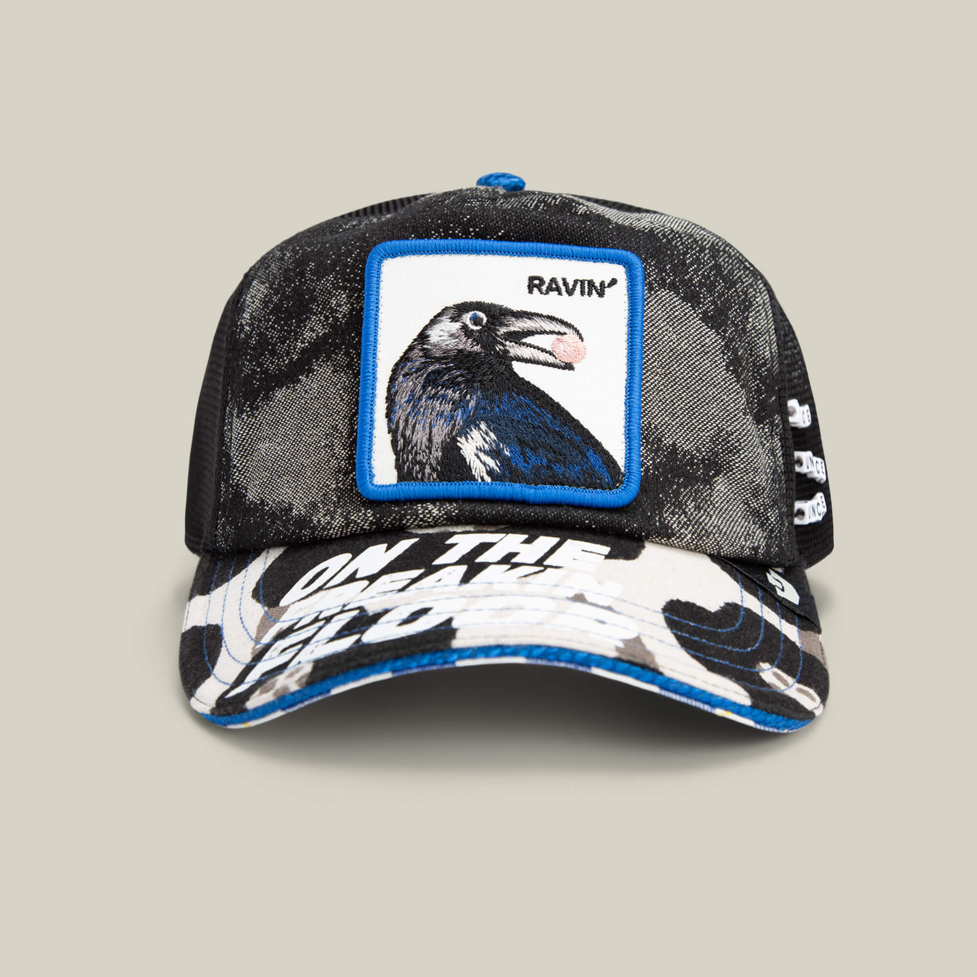 A black mesh Goorin Bros. Techno baseball cap with a raven patch, "RAVIN" text, and white graphic on the brim—ideal for raves or festival fashion—set against a plain background.