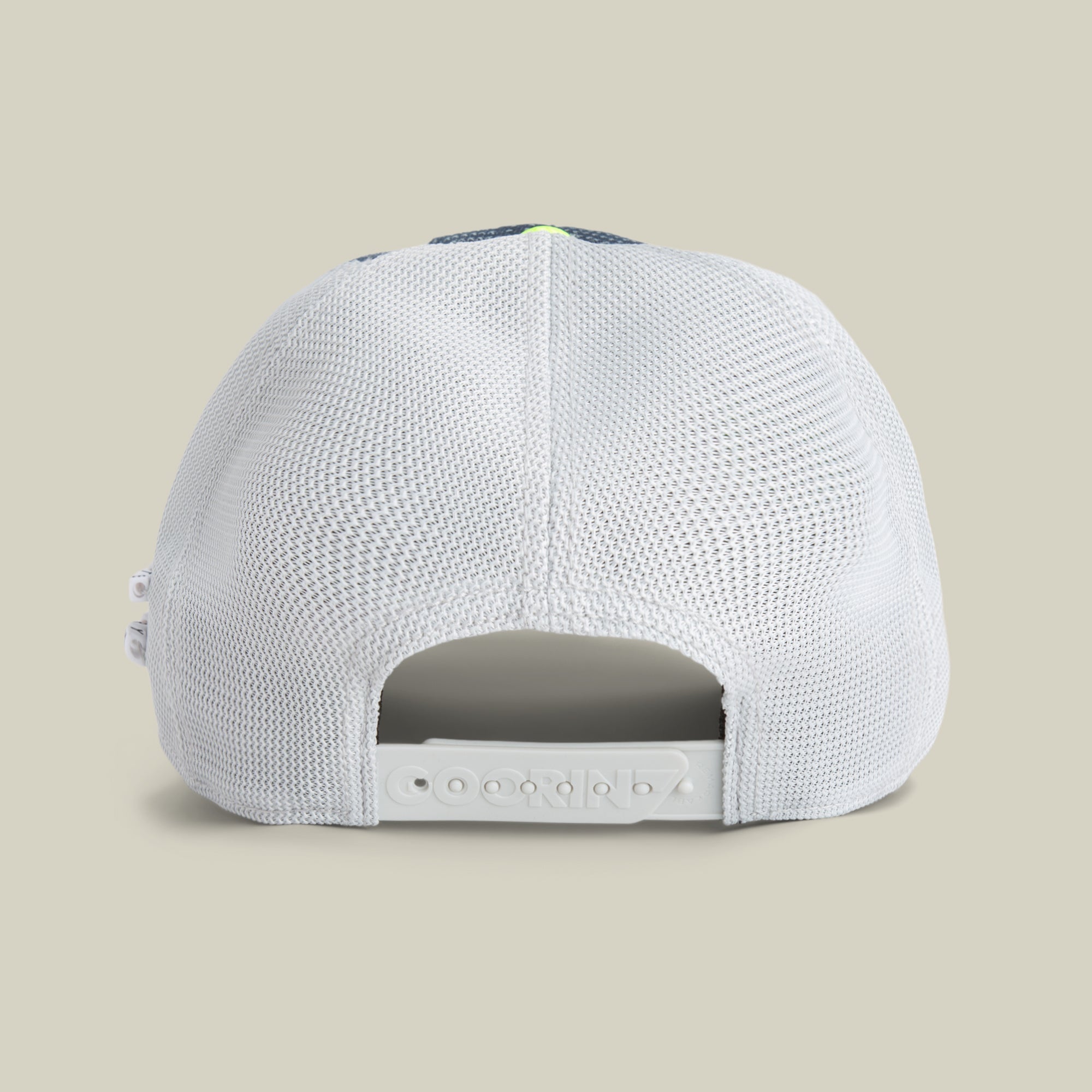 A back view of the white mesh Trance baseball cap by Goorin Bros., featuring an adjustable snapback closure against a beige background—ideal for festivals.