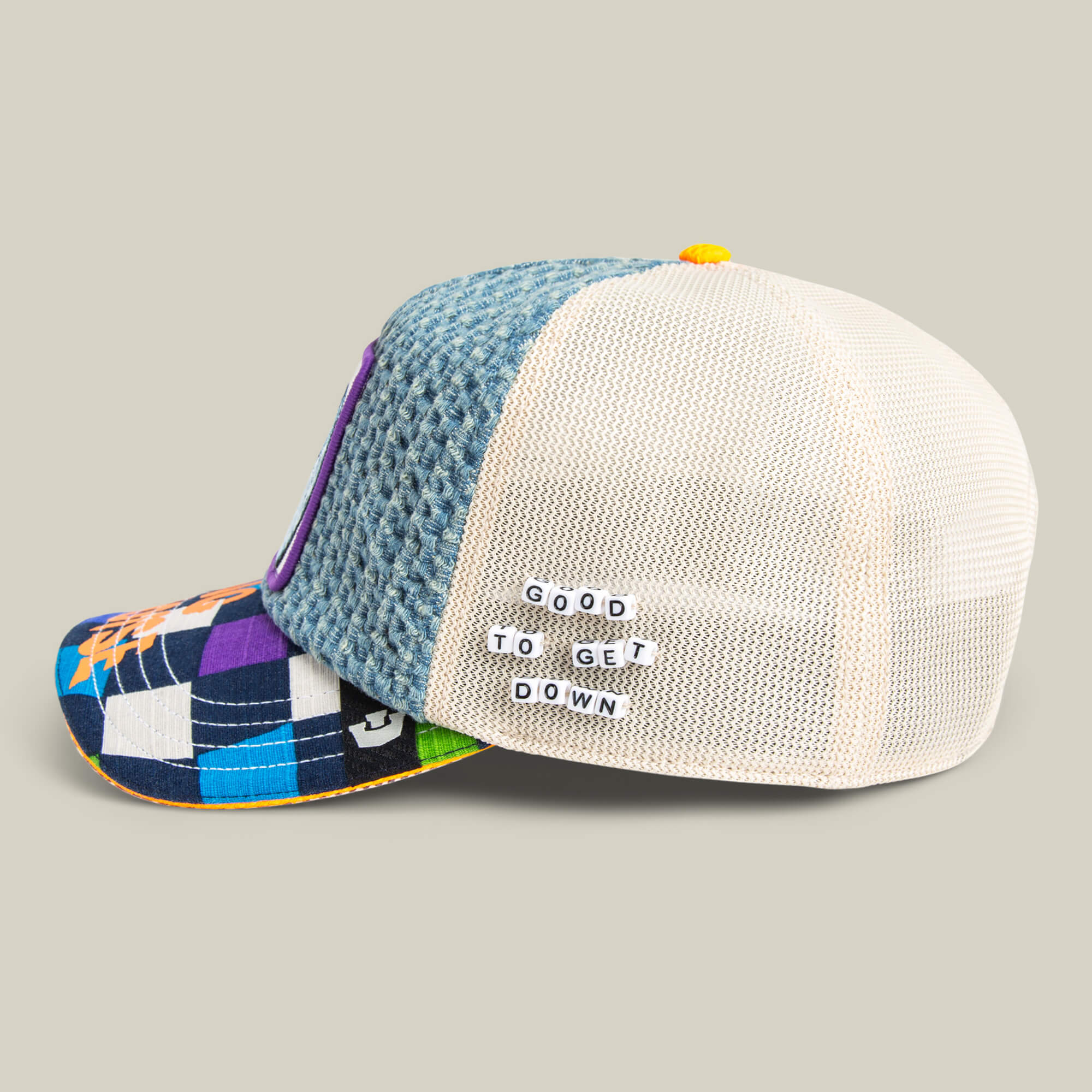 The Acid House trucker hat by Goorin Bros. features a blue and patterned front, mesh back, and "GOOD TO GET DOWN" on the side—perfect for your next Acid House night or laser dome adventure.