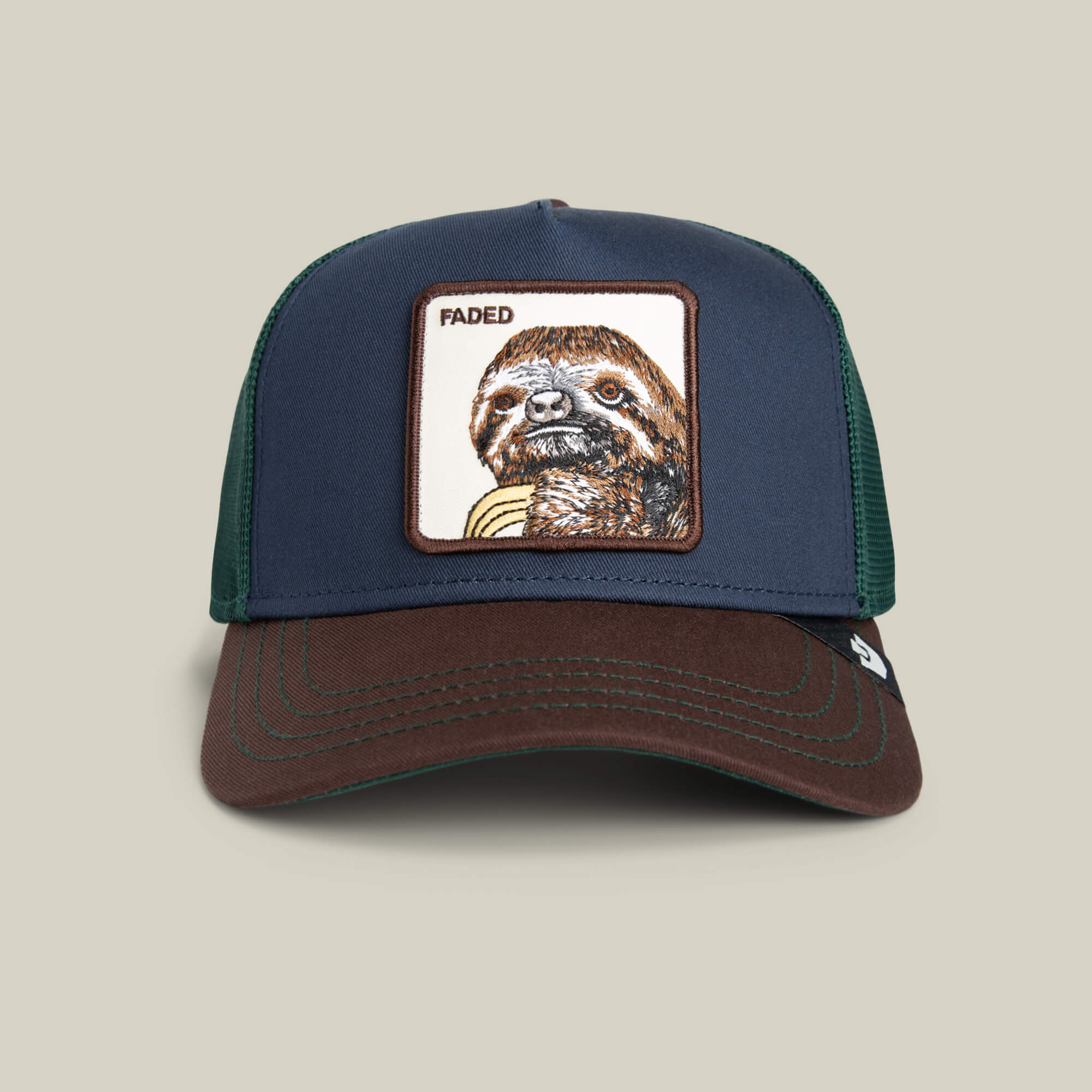 The Tricolor Sloth by Goorin Bros. is a stylish hat with a navy front, brown brim, green mesh back, and a patch showcasing a relaxed sloth under "FADED"—perfect for adding playful flair to your look.