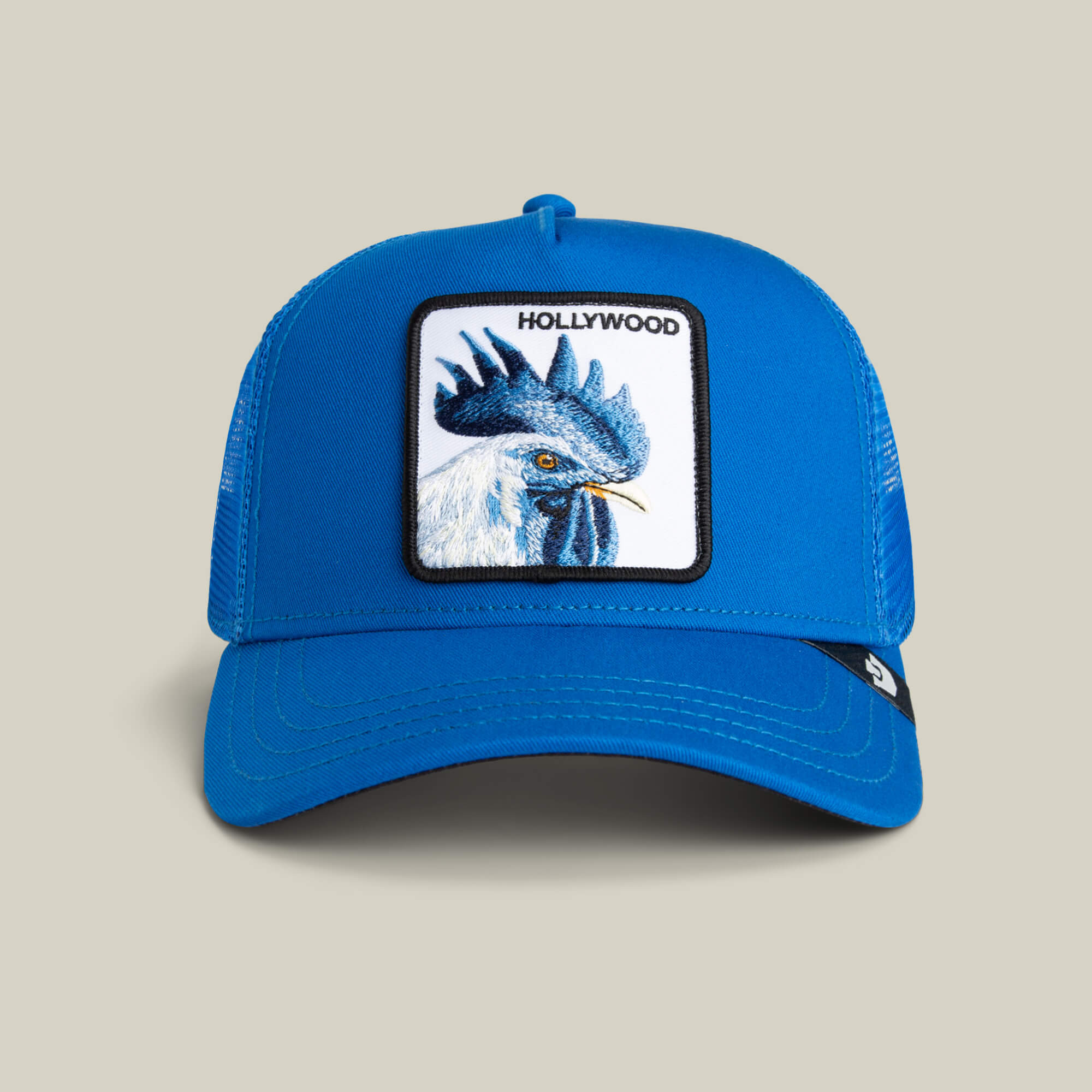 The Goorin Bros. Hollywood Rooster cap features a blue design with a bold rooster patch and "HOLLYWOOD" text—ideal for making a statement whether you're out in the city or seeking standout style.