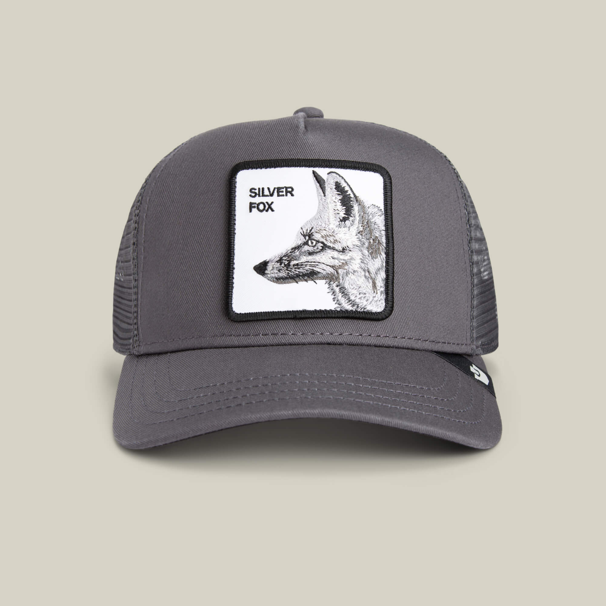 The Goorin Bros. Silver Foxxx is a stylish gray trucker hat with a mesh back, featuring a front patch with a black and white fox illustration and "Silver Foxxx" text—perfect for adding sophistication to any outfit.