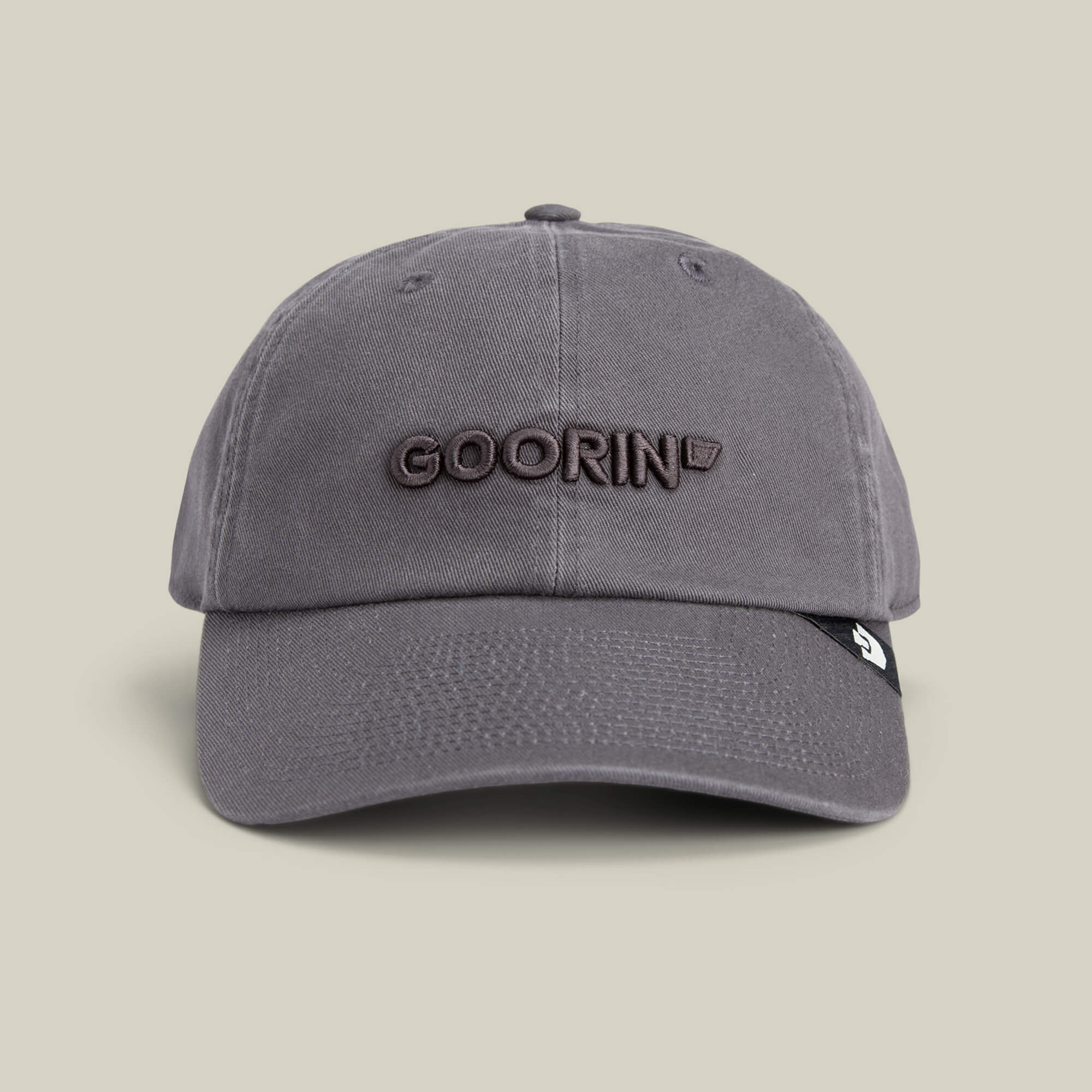 The Papa Core hat by Goorin Bros. features a gray curved brim and "GOORIN" embroidered in brown on the front, shown against a plain beige background.