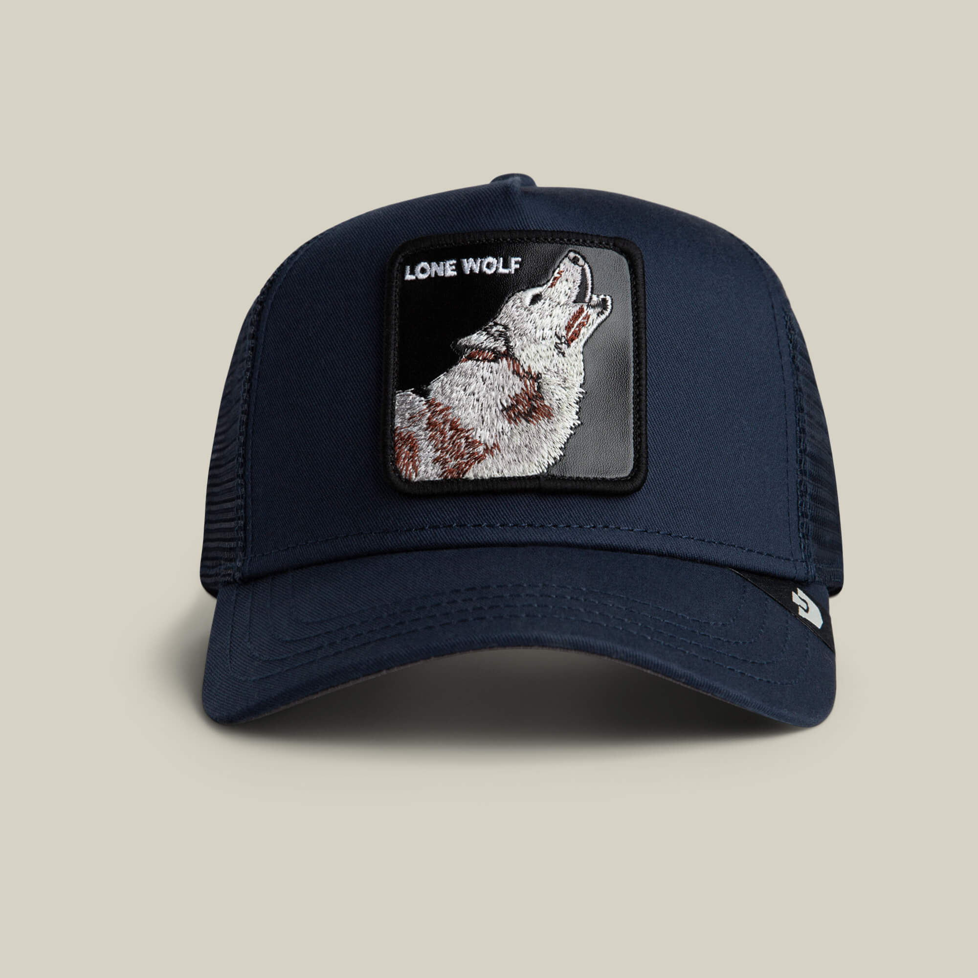 The Lone Wolf by Goorin Bros. is an EDGE-colored mesh trucker hat featuring a front patch of a howling wolf and bold LONE WOLF text, perfect for channeling outlaw energy.
