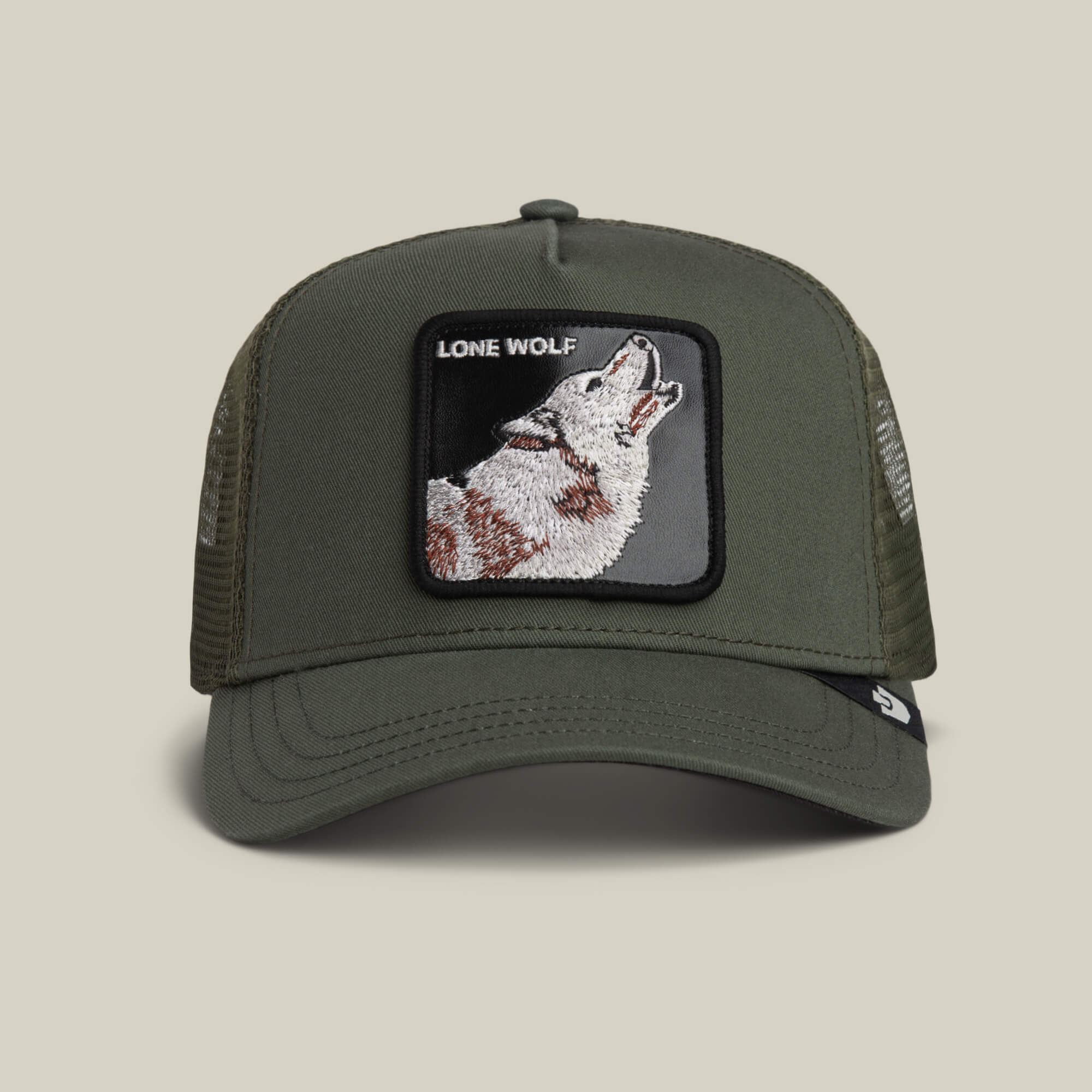 The Lone Wolf by Goorin Bros. is a PALM green trucker hat with a mesh back, featuring a howling wolf patch and "LONE WOLF" text on the front—ideal for those with true outlaw energy.