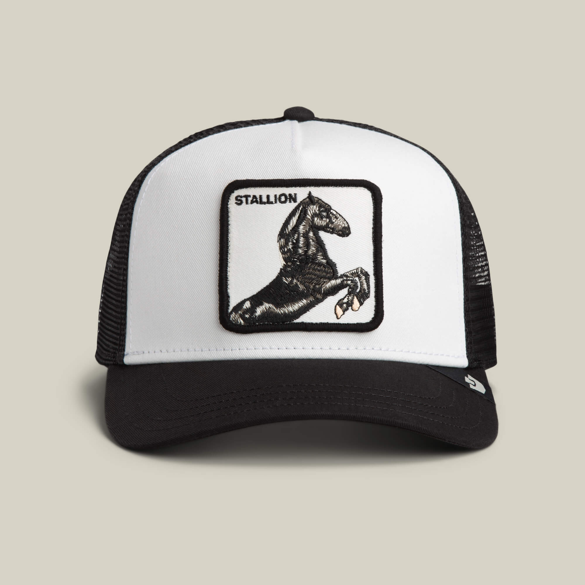 The Goorin Bros. Stallion Trucker in DUST/VOID features a front patch with a rearing black horse and the word STALLION above it.