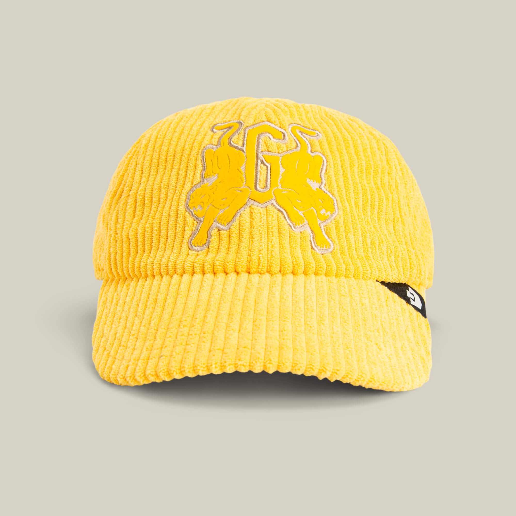 The Goorin Bros. Bleacher Report Cap is yellow with a corduroy crown, two embroidered bulls and a letter "G" on the front, plus a small black tag on the left side of the brim.