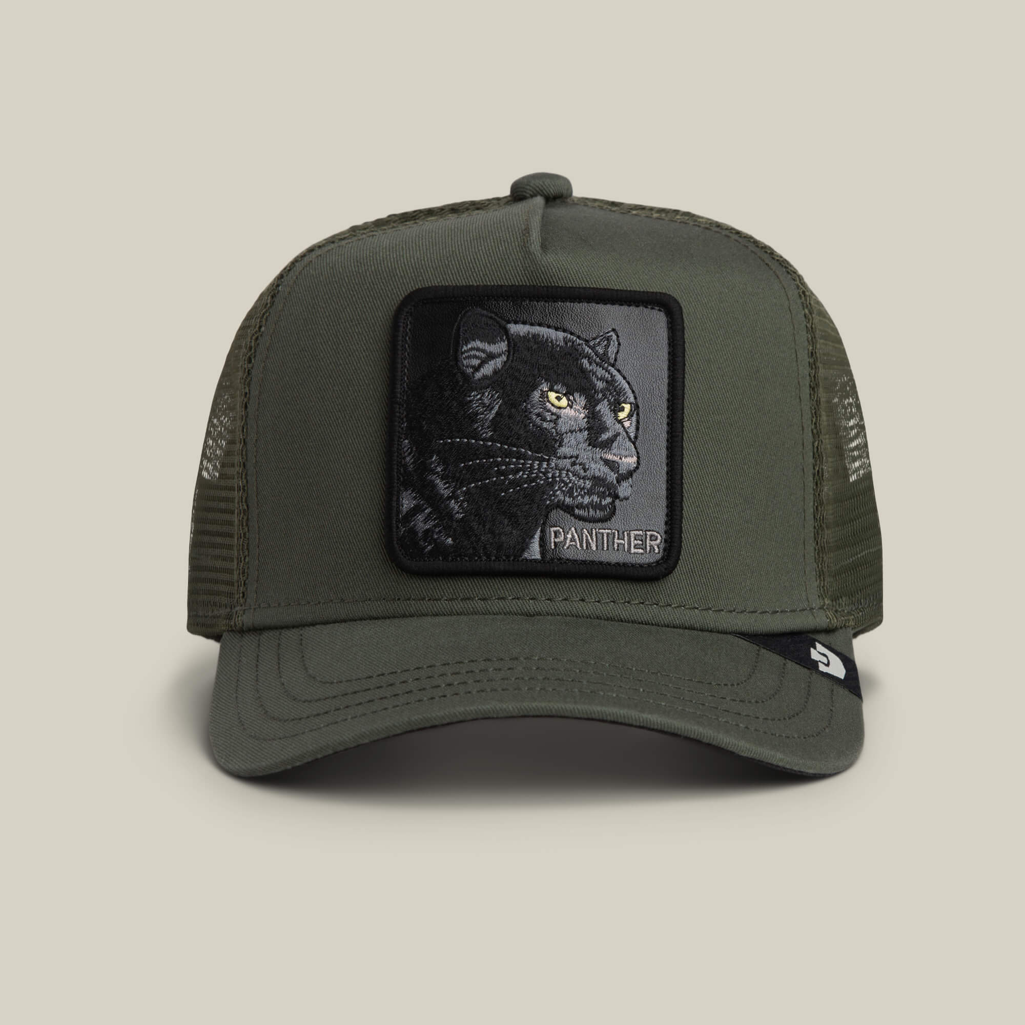 The Panther by Goorin Bros. is an olive green trucker cap with black mesh sides, featuring a front patch embroidered with a black panther head and “PANTHER.”.