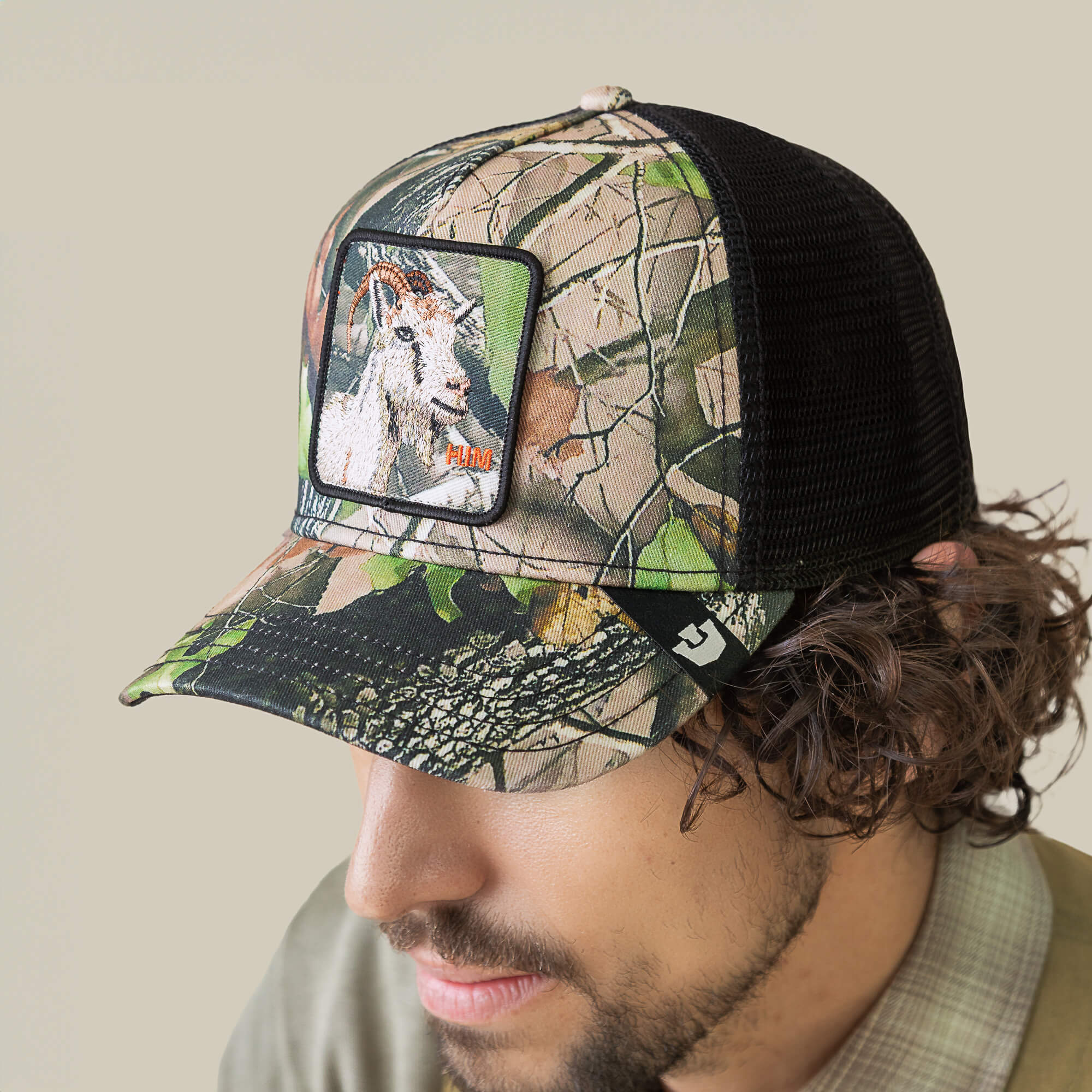 Wearing the Camouflage Goat by Goorin Bros., a forest-themed mesh trucker hat with a front patch that features an embroidered goat.