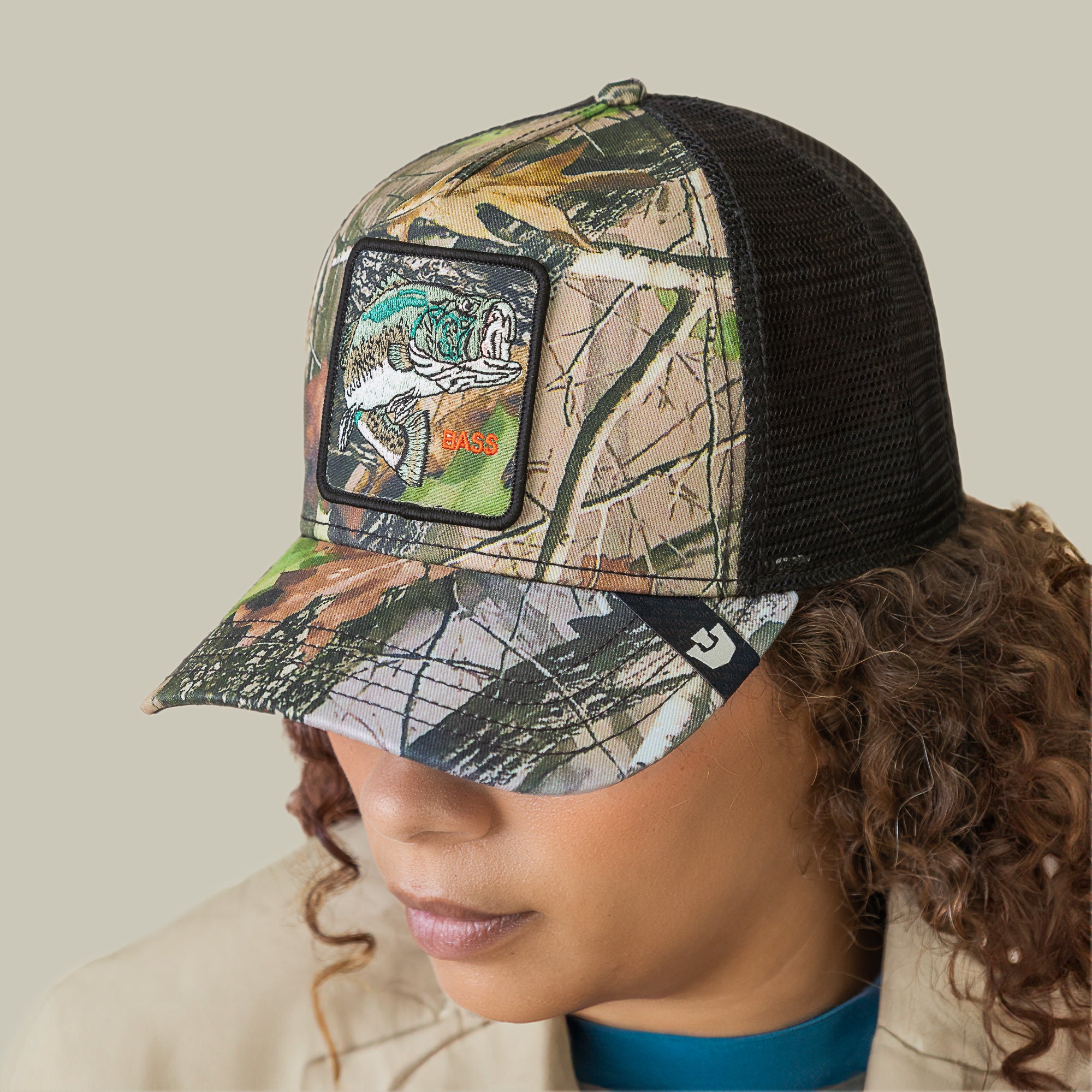 Wearing the Goorin Bros. Camouflage Bass trucker hat, featuring a mesh back and a bold bass patch, shows off stylish fishing pride.