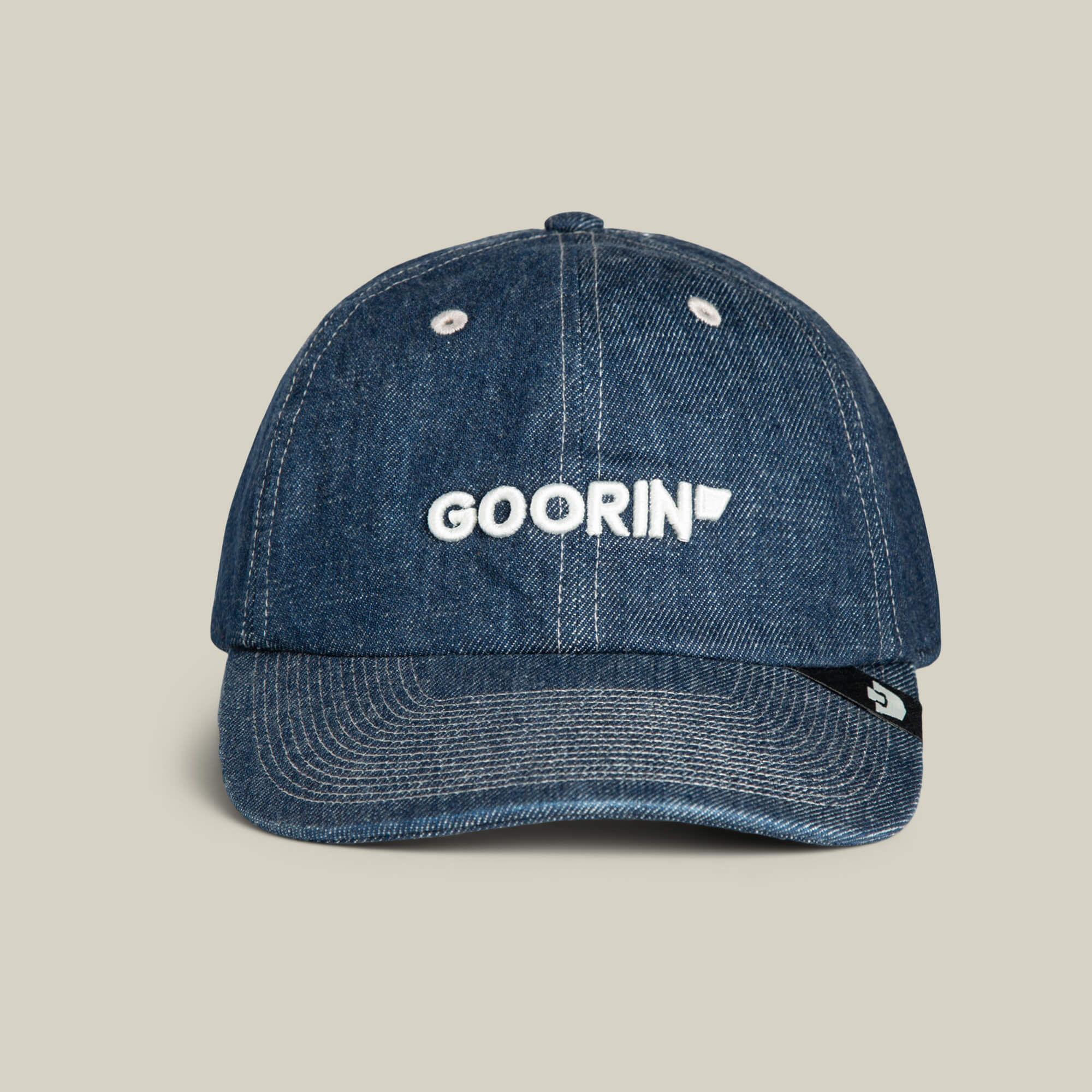 The Papa Core Denim cap by Goorin Bros. comes in PENNANT blue denim with white stitching, featuring the GOORIN wordmark embroidered on the front and a small black tag on the left side.
