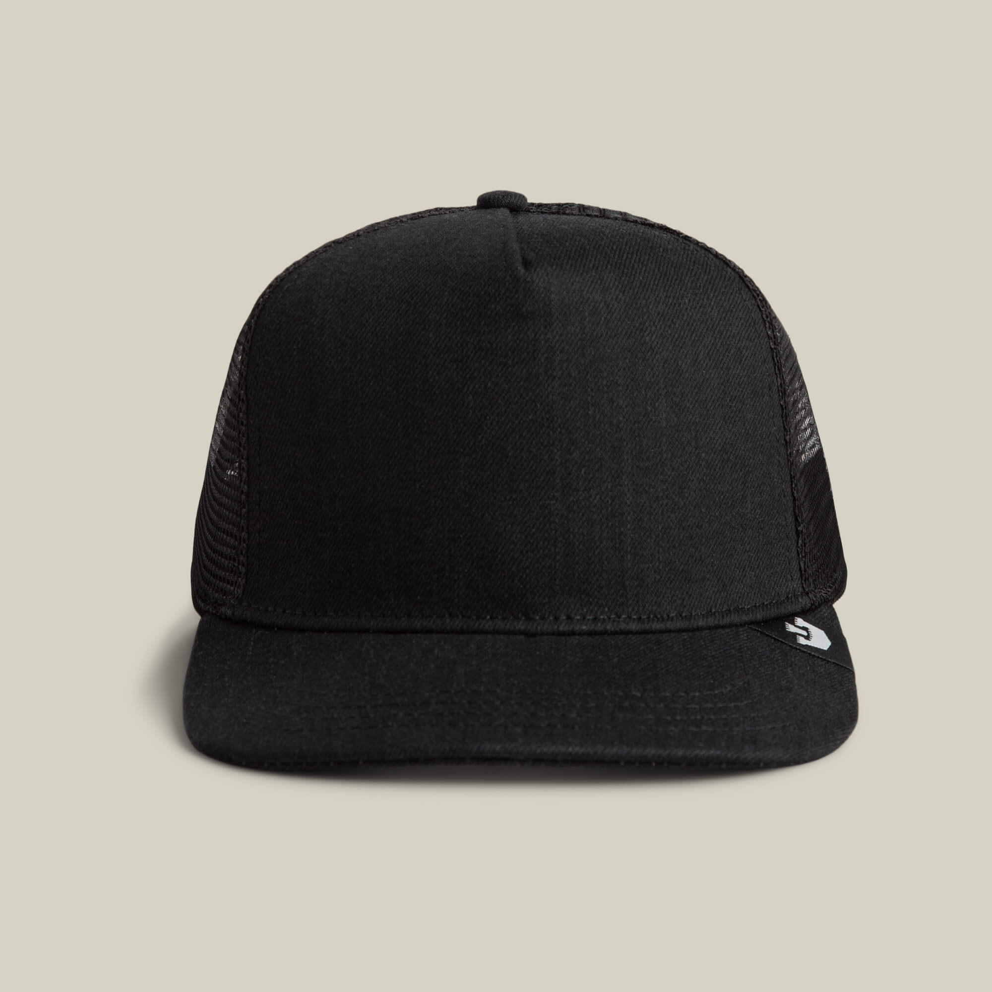 Front view of the Goorin Bros. Clean Denim Trucker hat, featuring mesh sides and a small white logo on the brim's left side for a clean denim look. Made in USA.