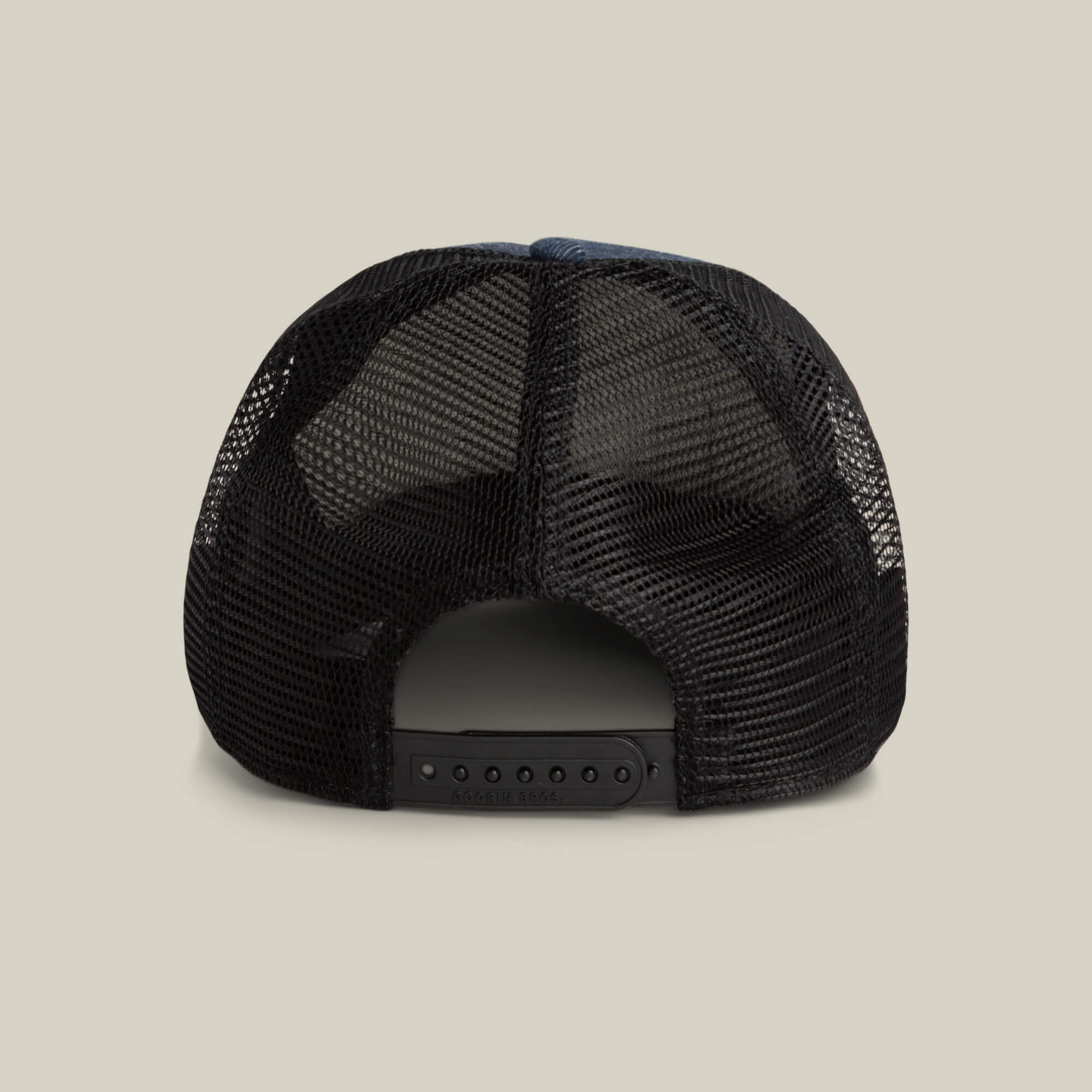 The image shows the back view of the Goorin Bros. Clean Denim Trucker, a black mesh denim hat with an adjustable snapback closure, set against a plain background.
