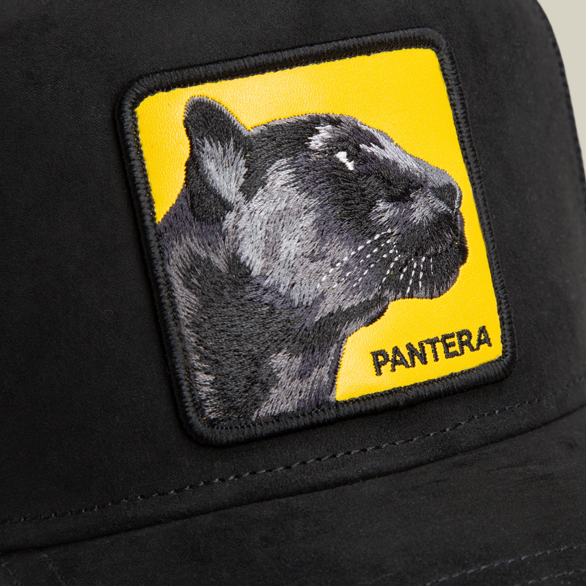 The Pantera Gialla by Goorin Bros. is a black hat featuring a yellow patch with an embroidered black panther head and "Pantera Gialla" text—ideal for pairing with agile sneakers or luxe microsuede for a standout look.